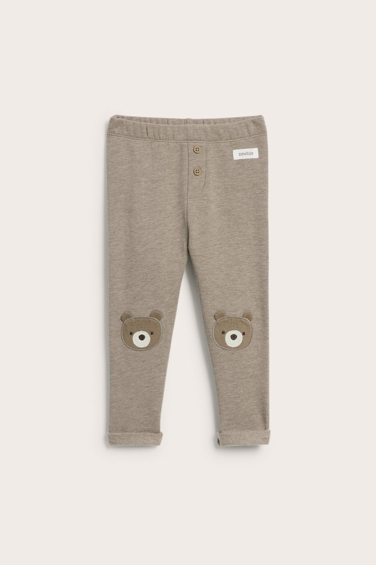 Front view of brown melange kid's leggings with elastic waist, decorative buttons, and bear face knee appliqués.