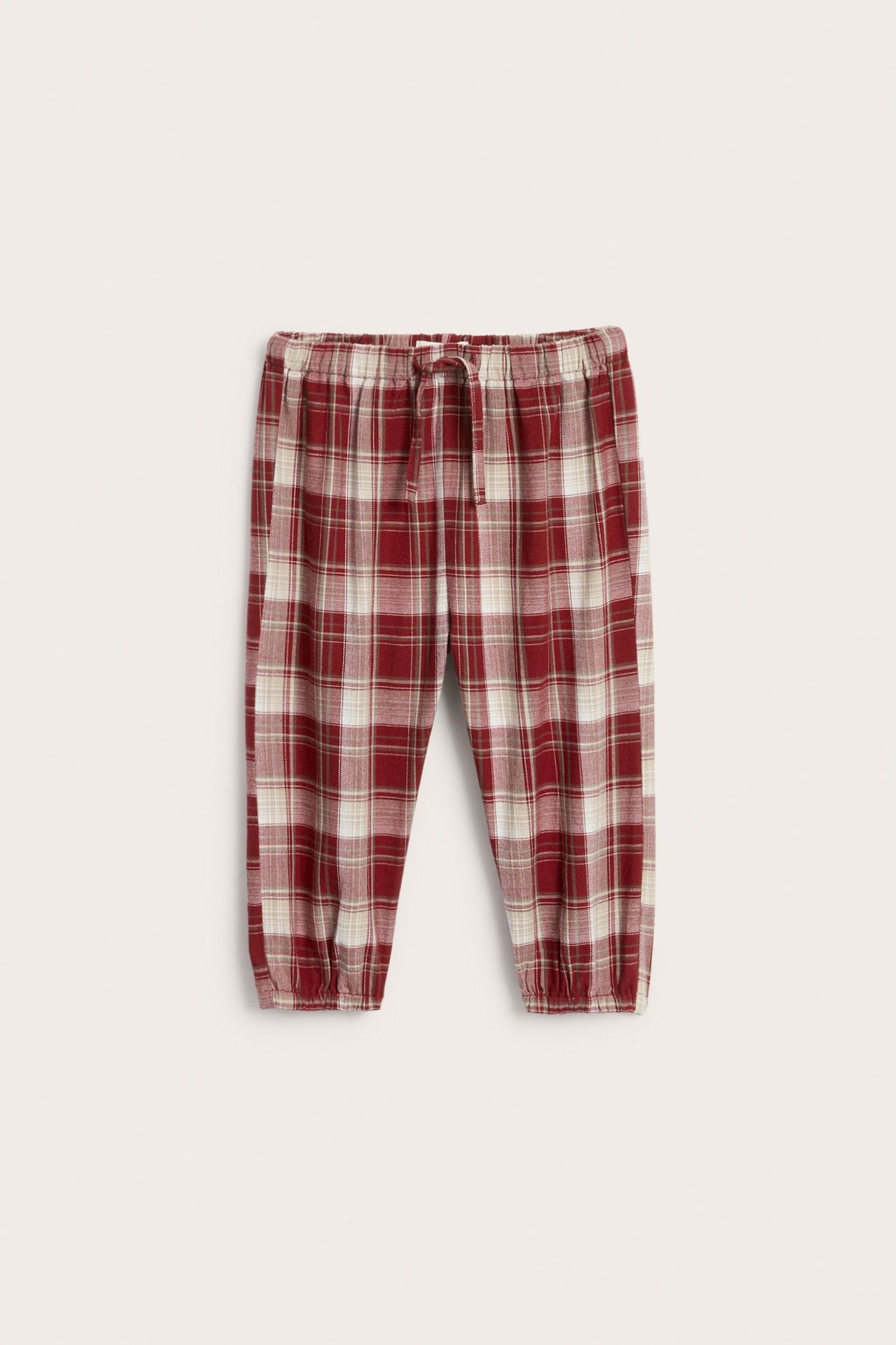 Rote gewebte Puff-Hosen aus Baumwolle mit Karo-Muster, elastischer Taille und Beinöffnungen.