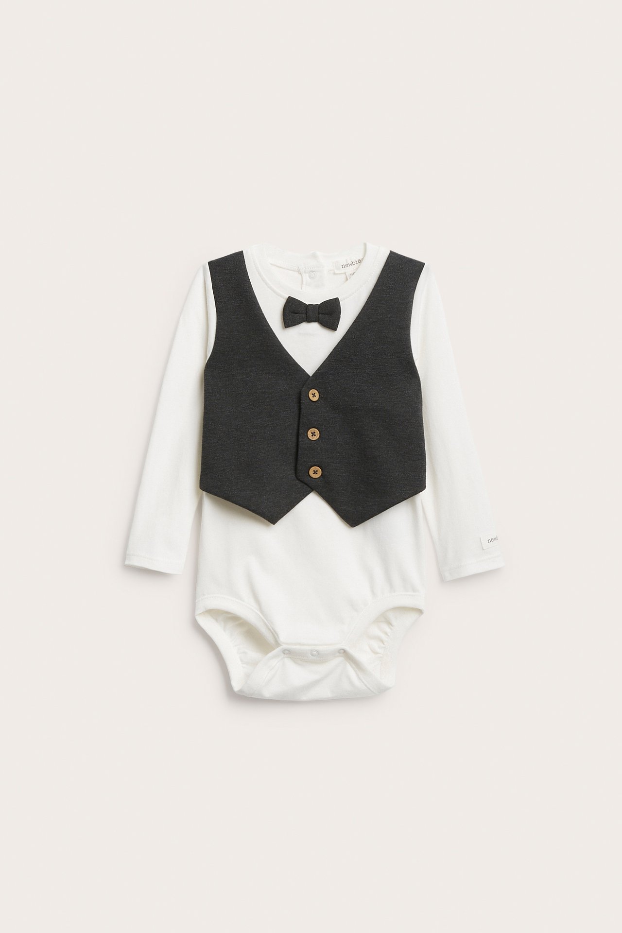 Front view of a baby's white long-sleeved bodysuit with a dark grey vest and bow tie illusion.