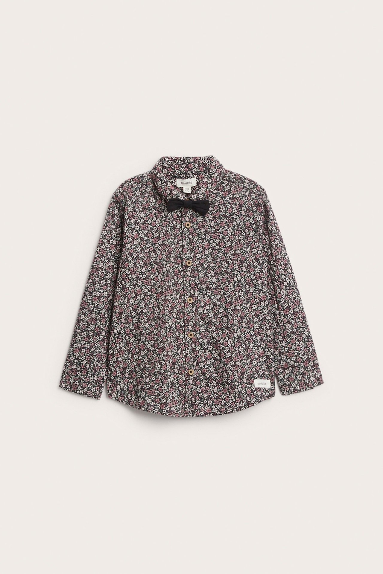 Front view: Kid's black floral cotton shirt with a collar, buttons, and a black bow tie.