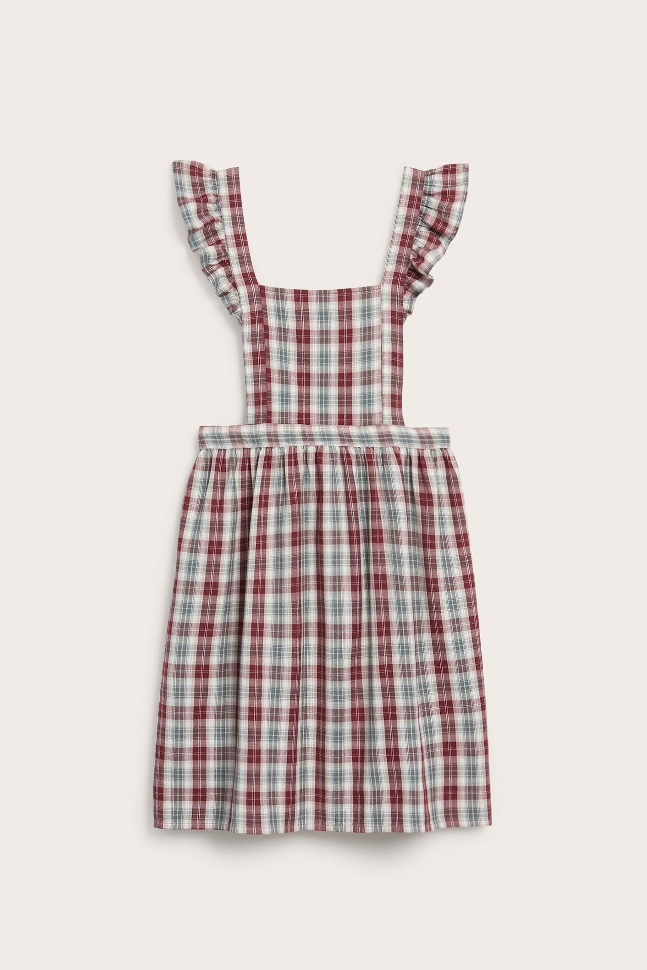 Vorderansicht: Damen-Schürzenkleid aus roter, karierter Baumwolle mit Rüschenriemen und Bindebändern.