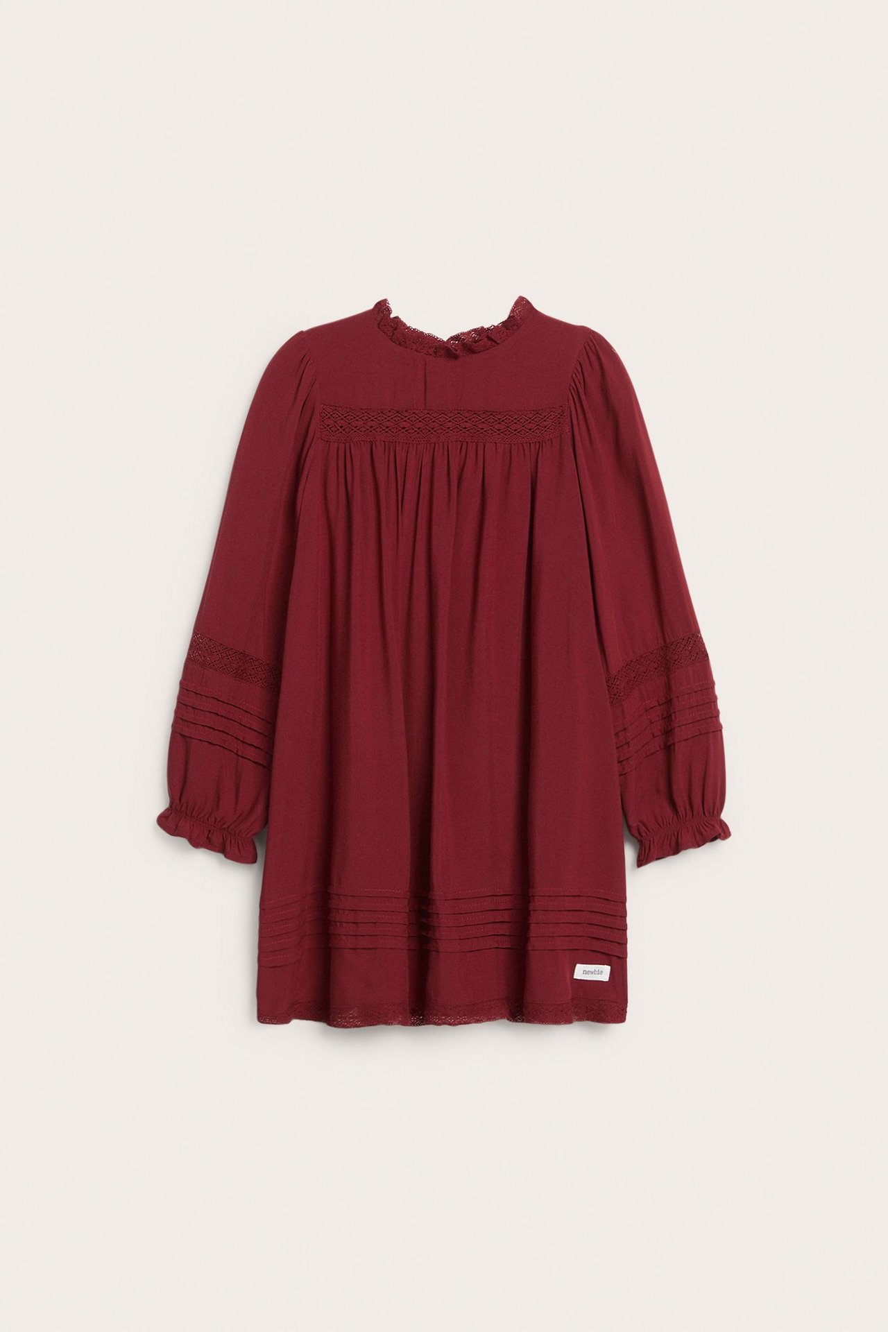 Front view, kid's red viscose dress with lace trim at ruffled neck, lace and pintucks on sleeves and hem.