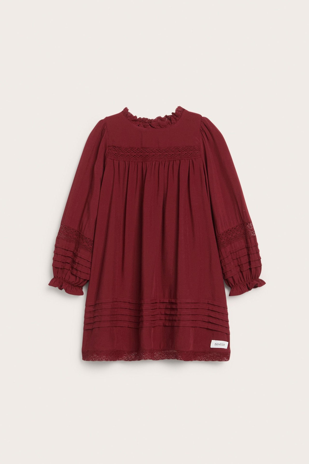 Front view, kid's red viscose dress with lace and pintuck details, and ruffled cuffs.