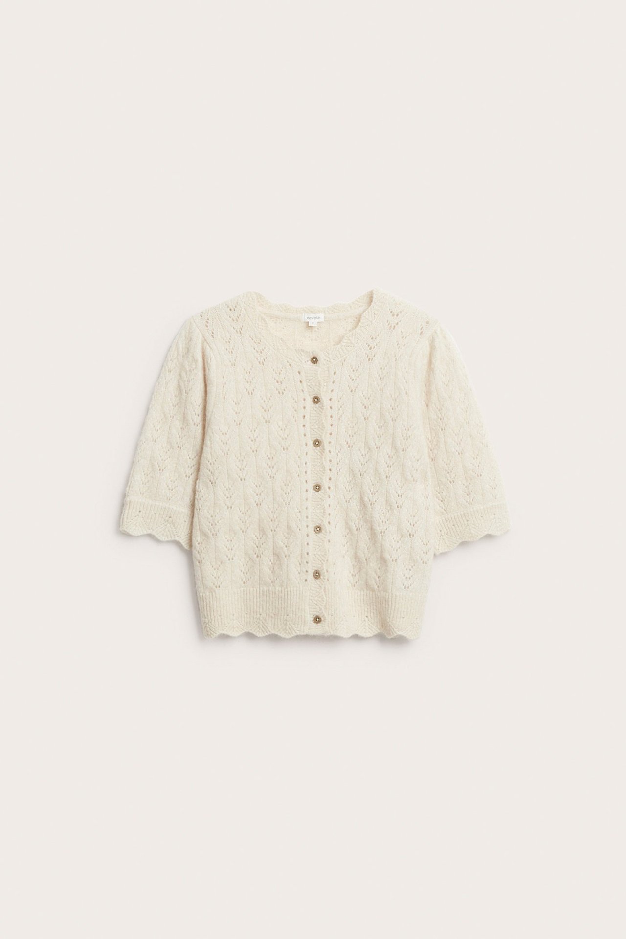 Front view: Light beige patterned knit women's cardigan with short puff sleeves, front buttons, and scalloped edges.