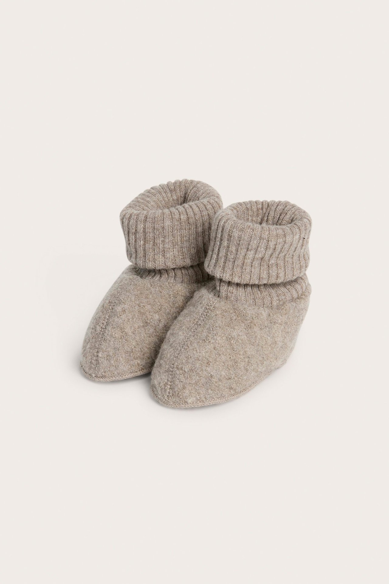 Front view of melange brown wool baby booties with folded ribbed cuffs.
