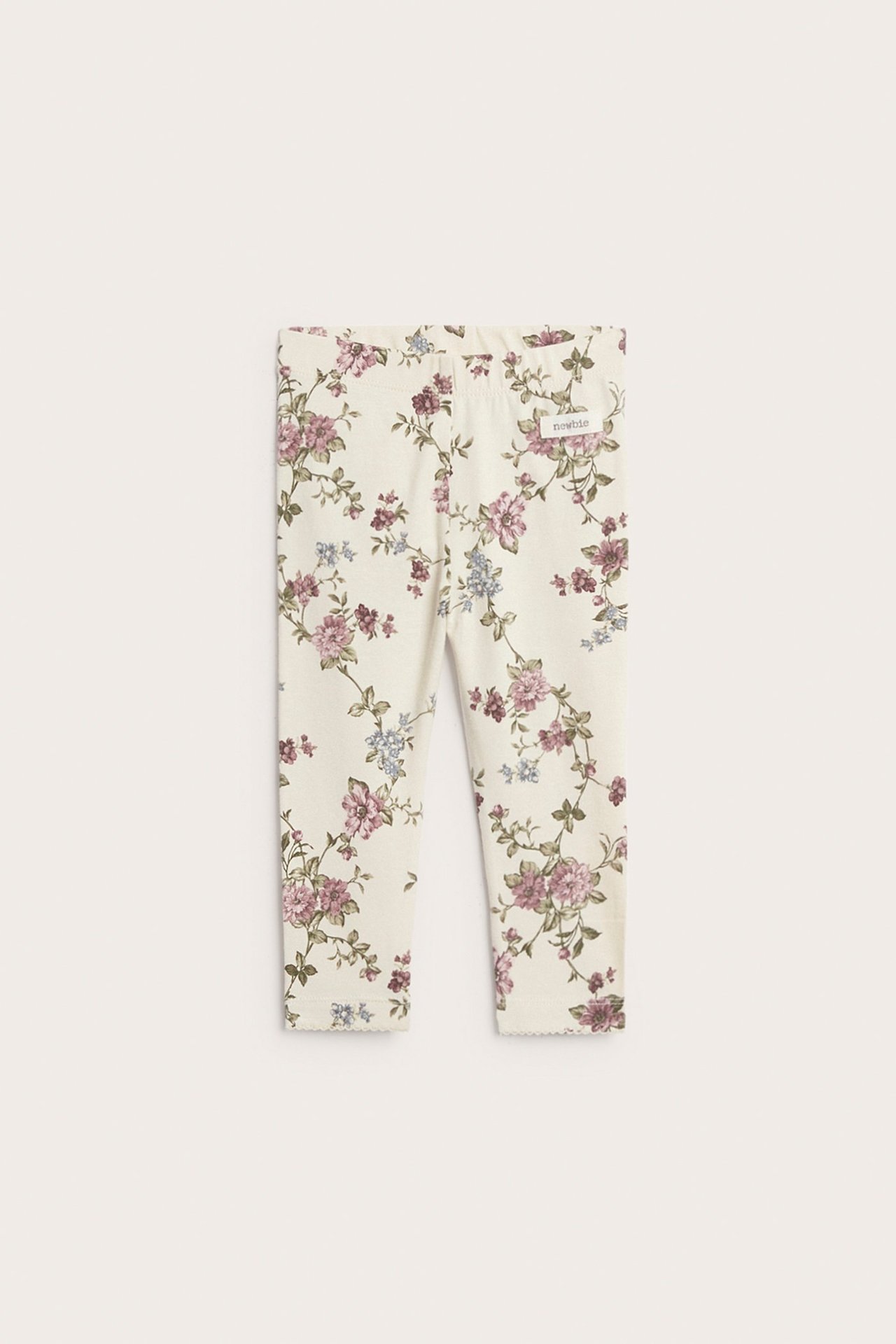 Vorderansicht: Hellbeige florale Leggings mit rosa und blauen Blumen, elastischem Bund und gewellten Bündchen.