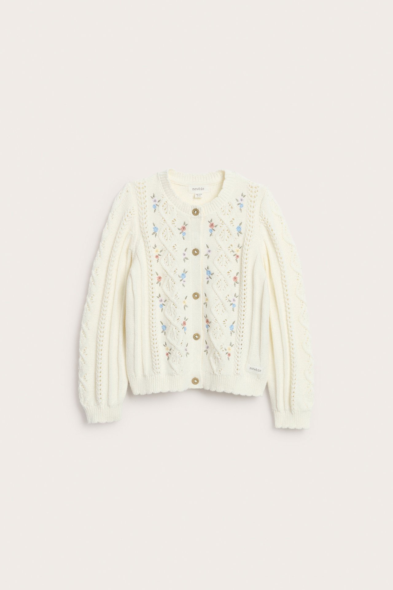 Front view of a kid's off-white cotton knit cardigan with floral embroidery and buttons, featuring cable knit sleeves.