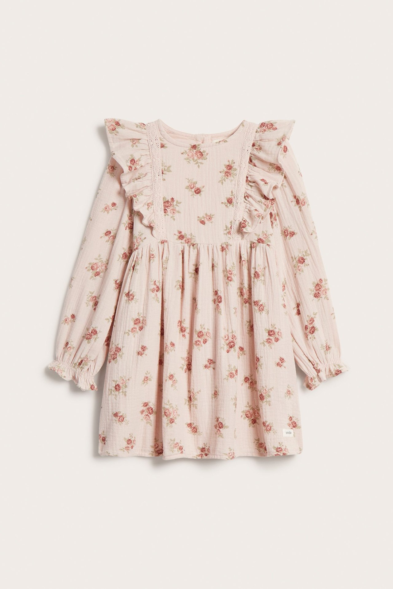 Front view of a light pink kid's dress with a floral print, long sleeves, and ruffles.