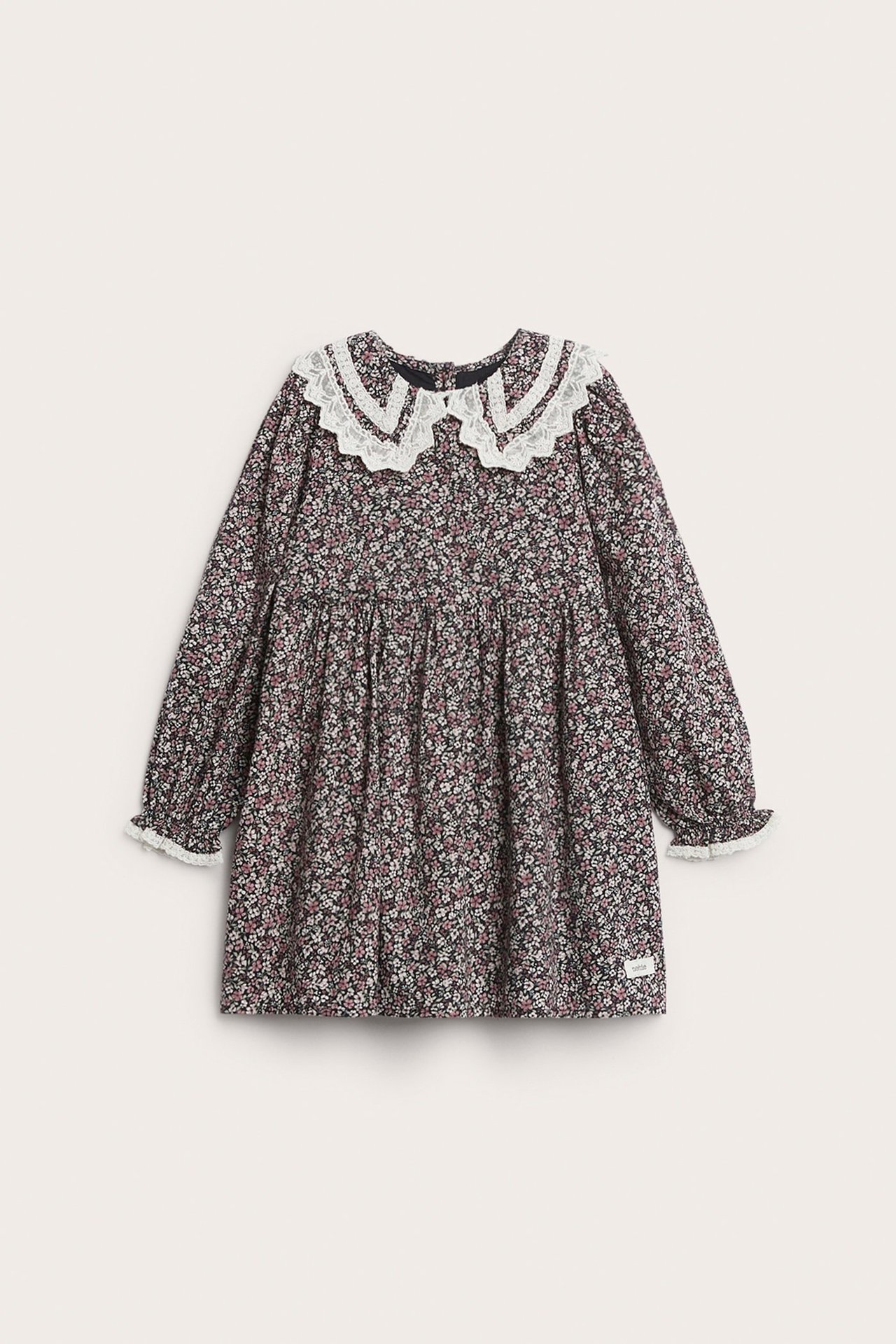 Front view: Kid's black floral cotton dress with white lace collar and lace cuffs.
