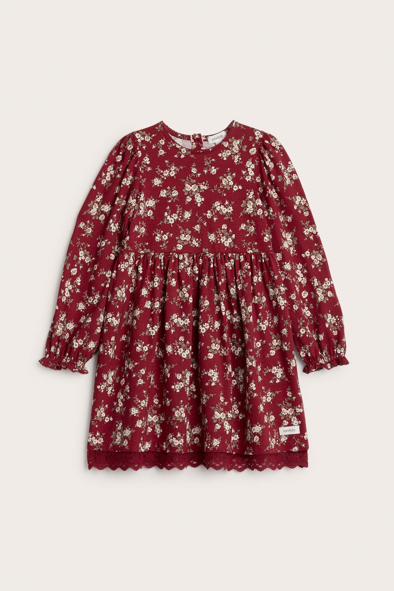 Front view of a kid's red floral jersey dress with puff sleeves and a lace-trimmed hem.