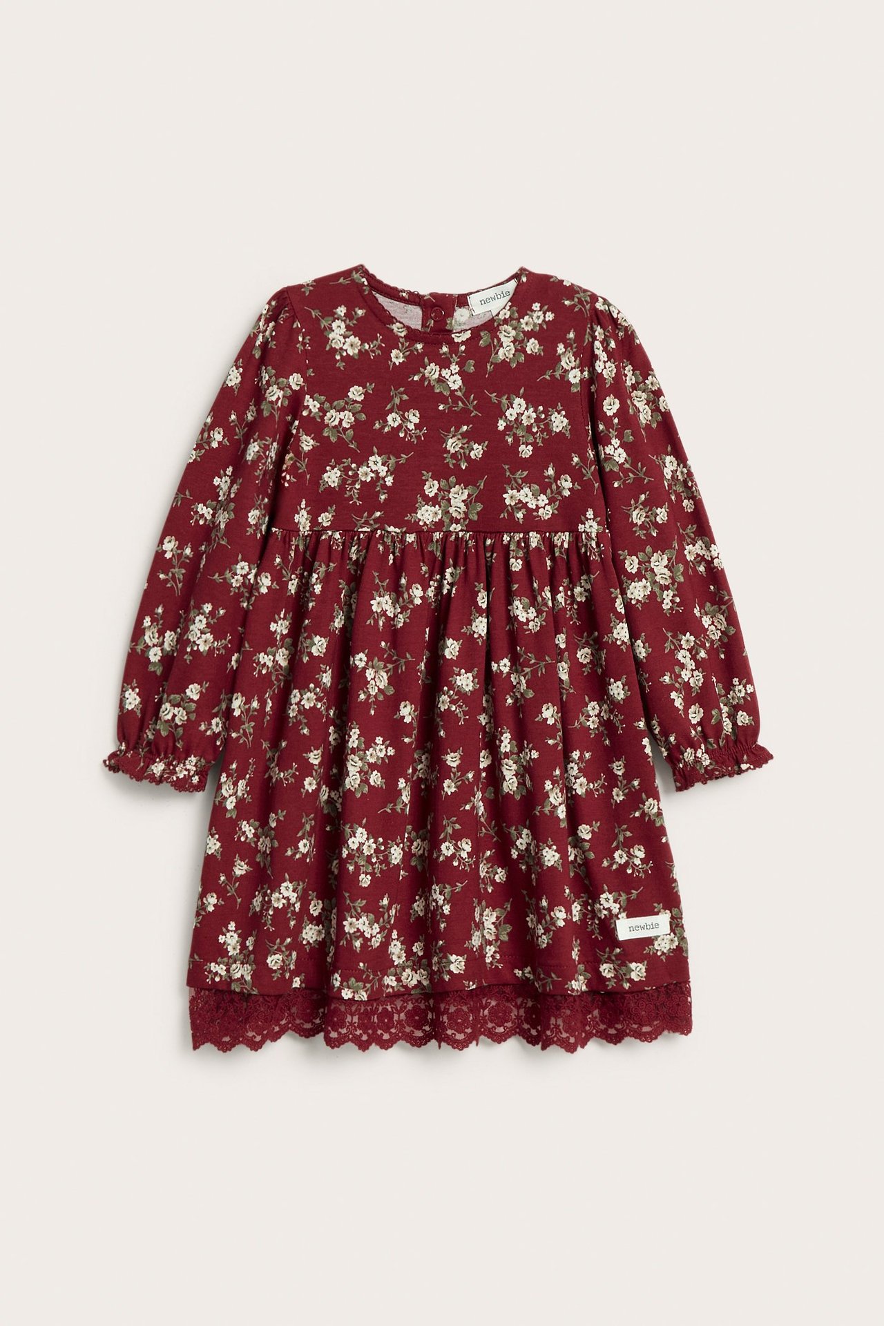 Front view of a kid's red floral cotton jersey dress with puff sleeves and lace hem.