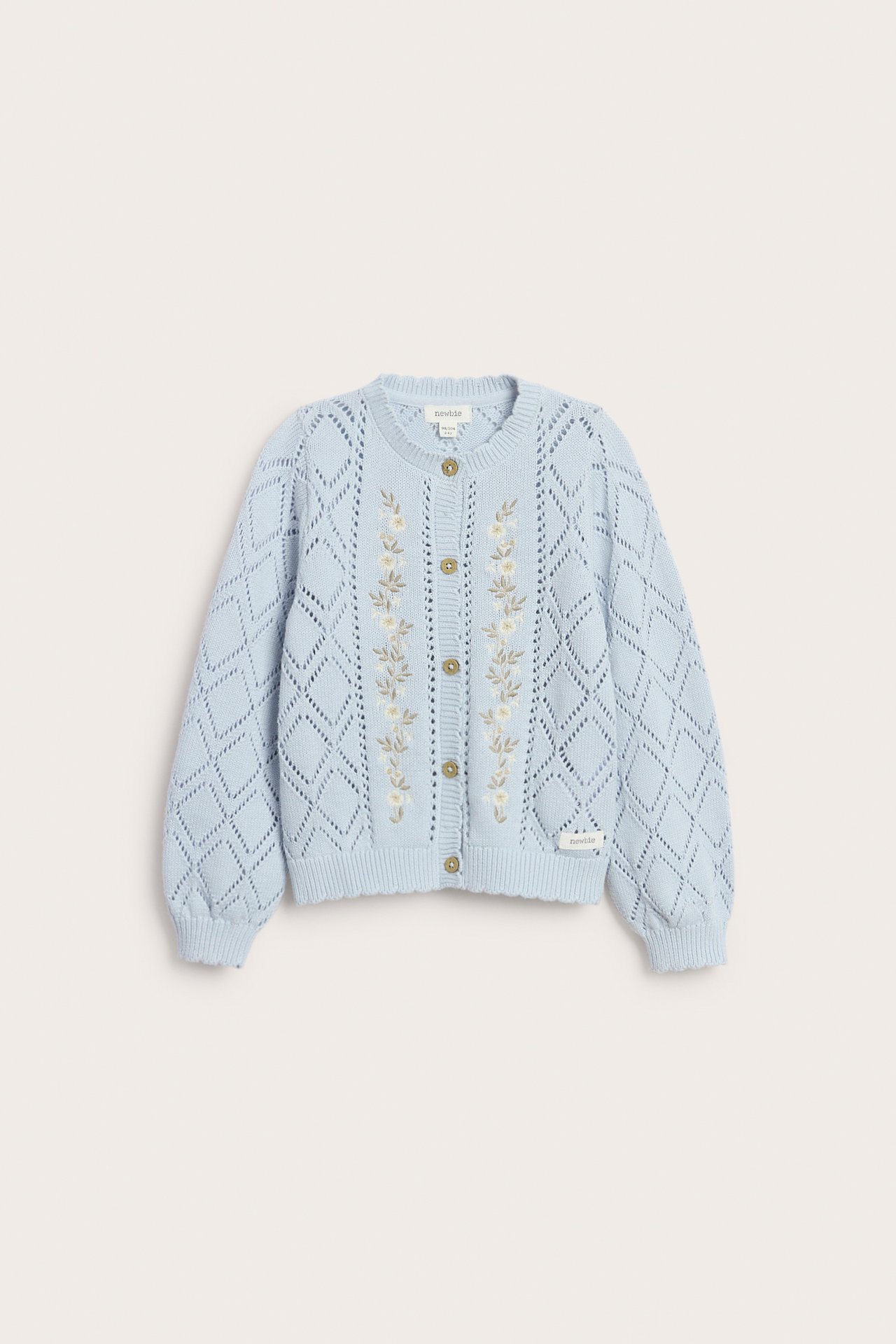 Front view of a light blue patterned knit kid's cardigan with embroidered flowers and front Newbie buttons.