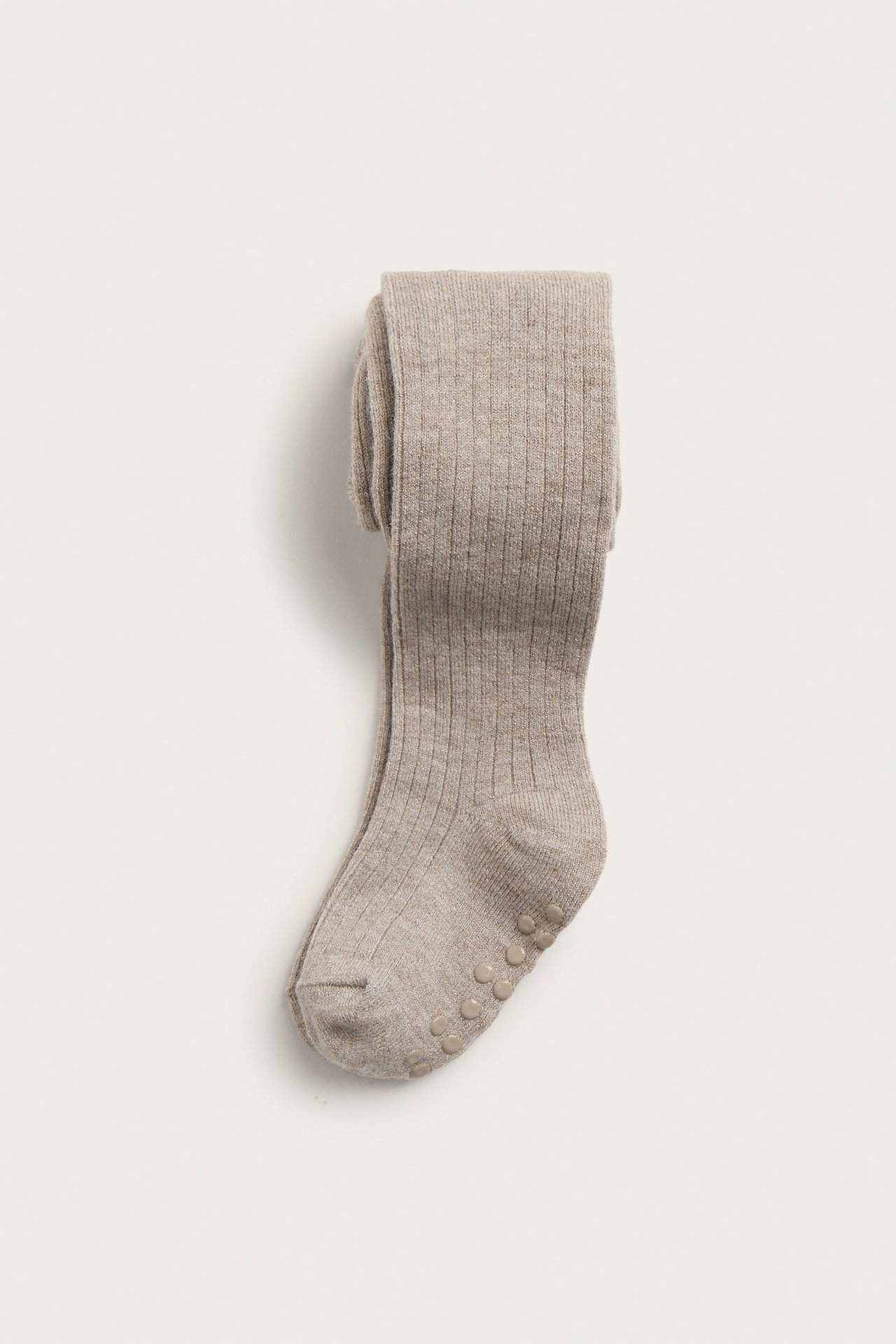 Vorderansicht gefalteter beiger gerippter Baby-Strumpfhosen aus Wollmischung mit Anti-Rutsch-Noppen.