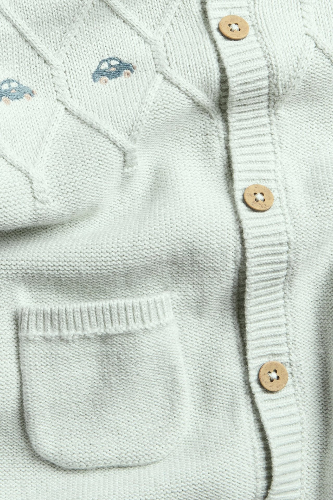 Hellblaue, strukturierte gestrickte Jumpsuit für Kinder mit Stickerei, Knöpfen und Rippbündchen.