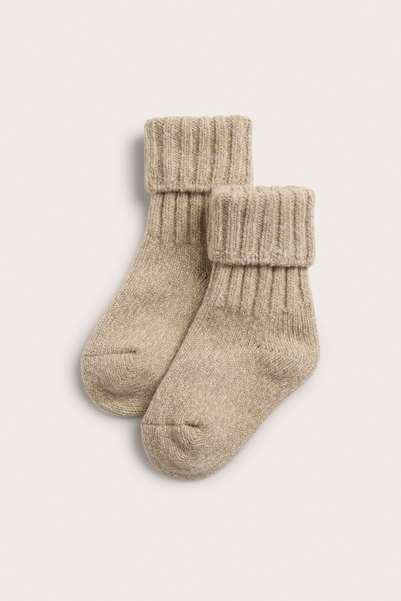 Top view of a pair of melange beige wool blend socks with ribbed, folded cuffs.