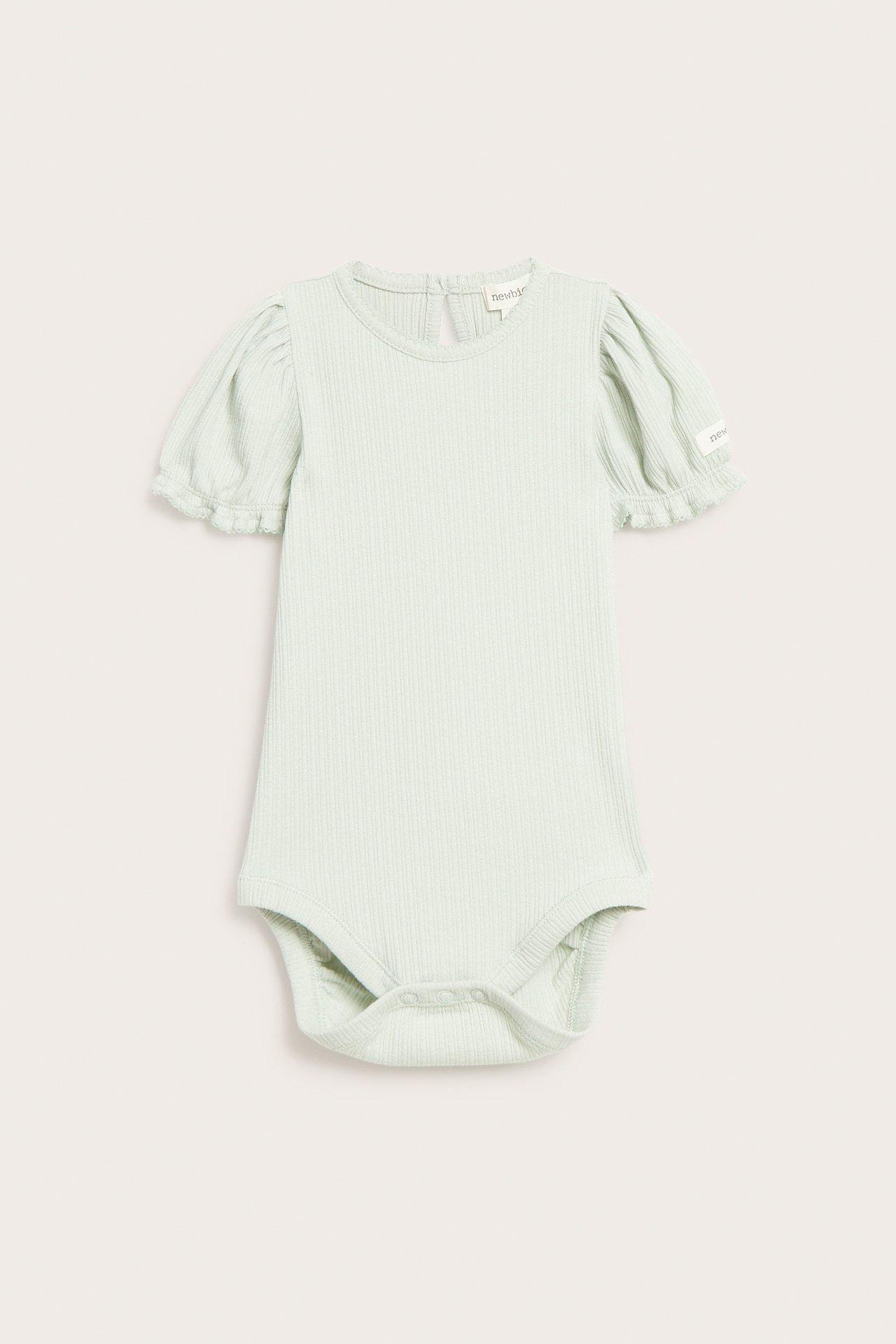 Front view of a light green ribbed jersey baby bodysuit with short puff sleeves, picot trim, and snap fasteners.