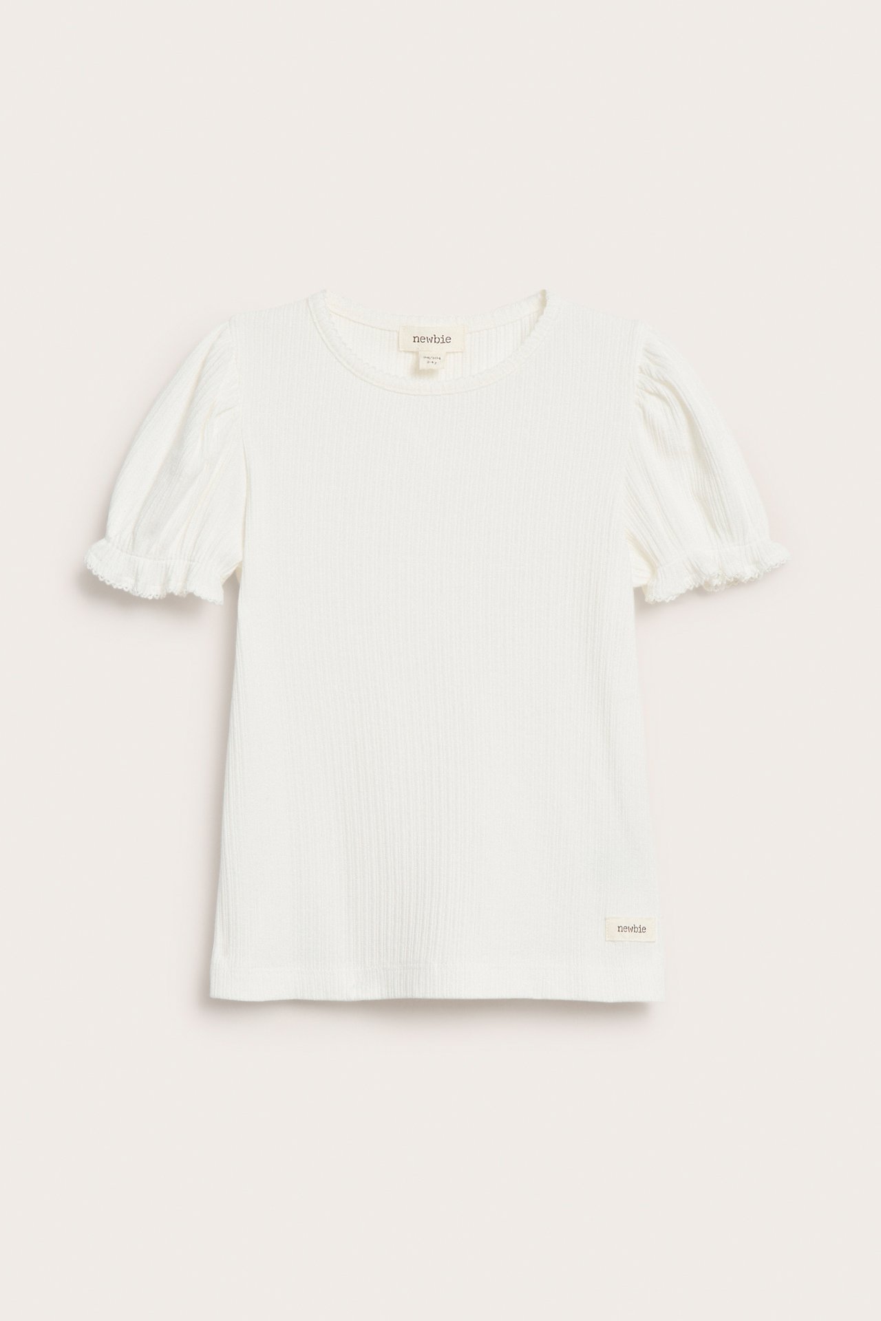 Front view of an off-white ribbed short-sleeved top with puff sleeves and picot trim.