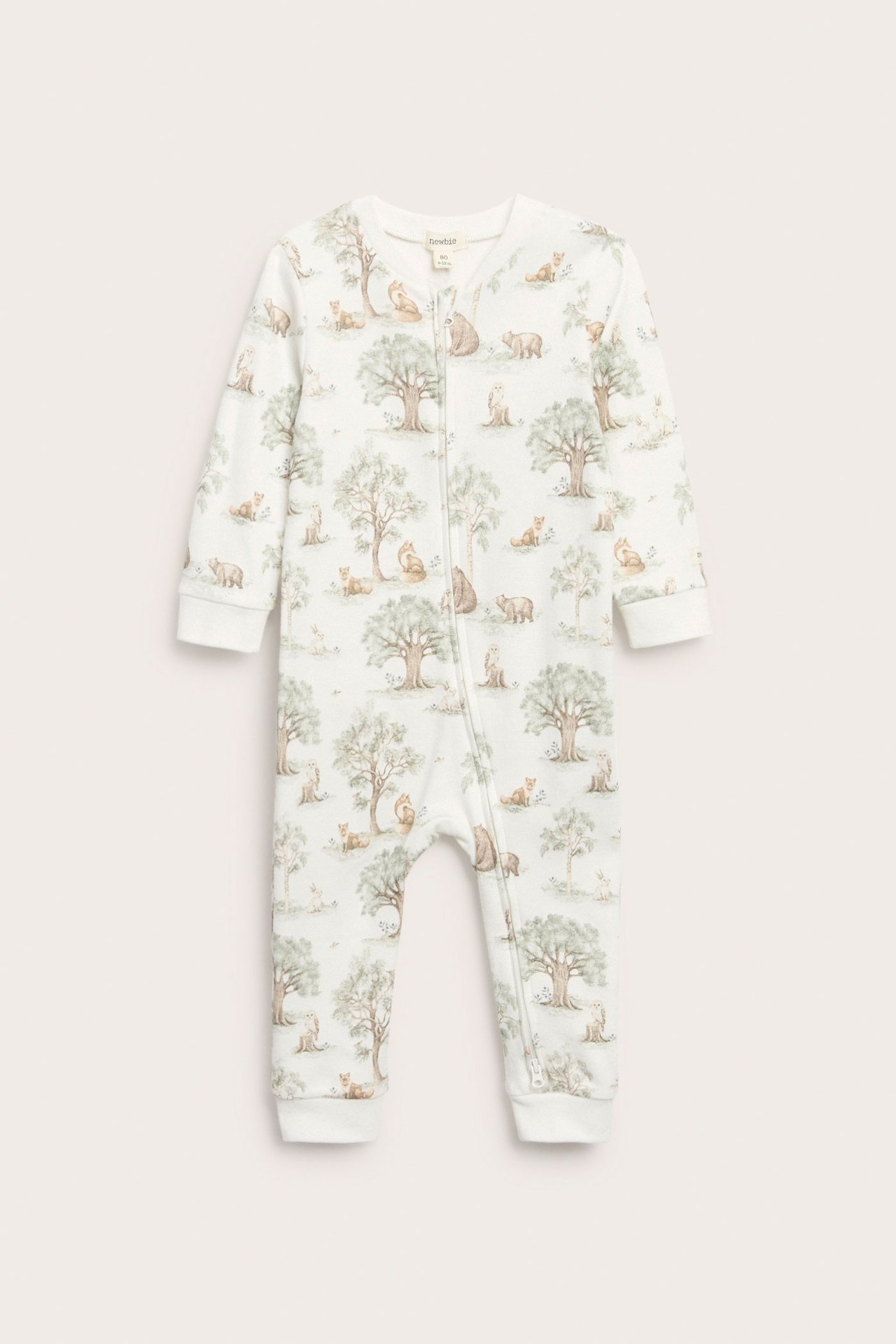 Front view, off-white cotton baby romper with a forest animal print and a two-way zipper closure.