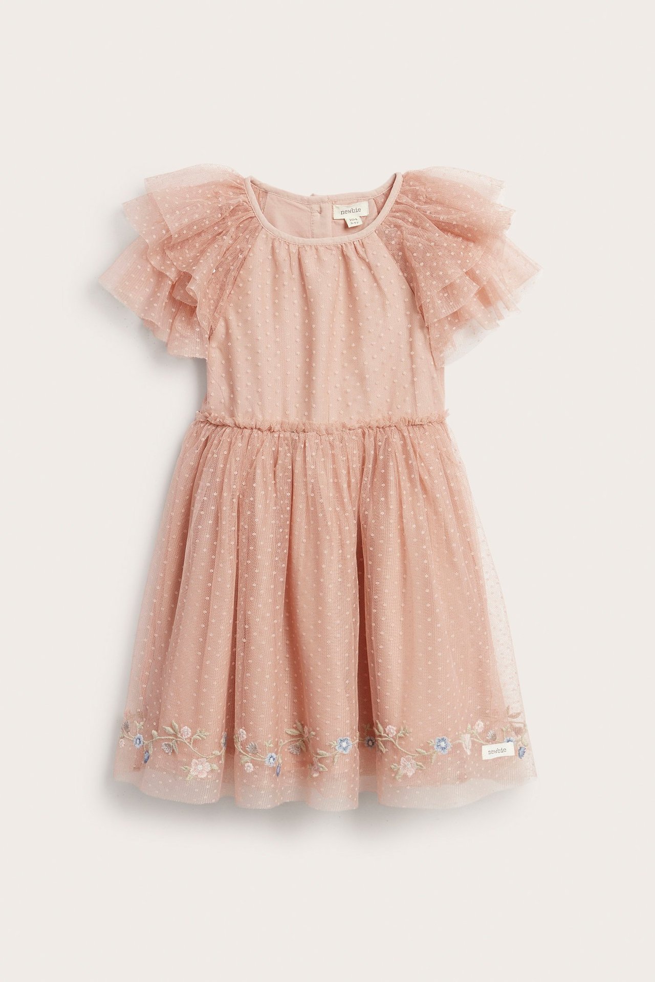 Front view of a pink kid's dotted mesh dress with tiered ruffle sleeves and floral embroidery at the hem.