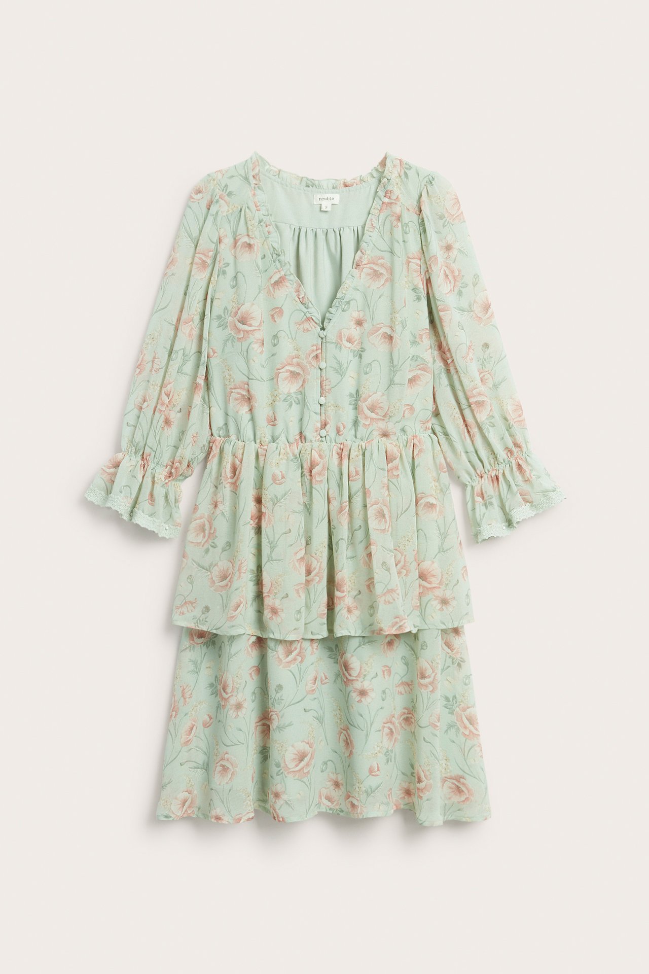 Front view of a light green floral chiffon tiered dress with ruffles, V-neck, and covered buttons.