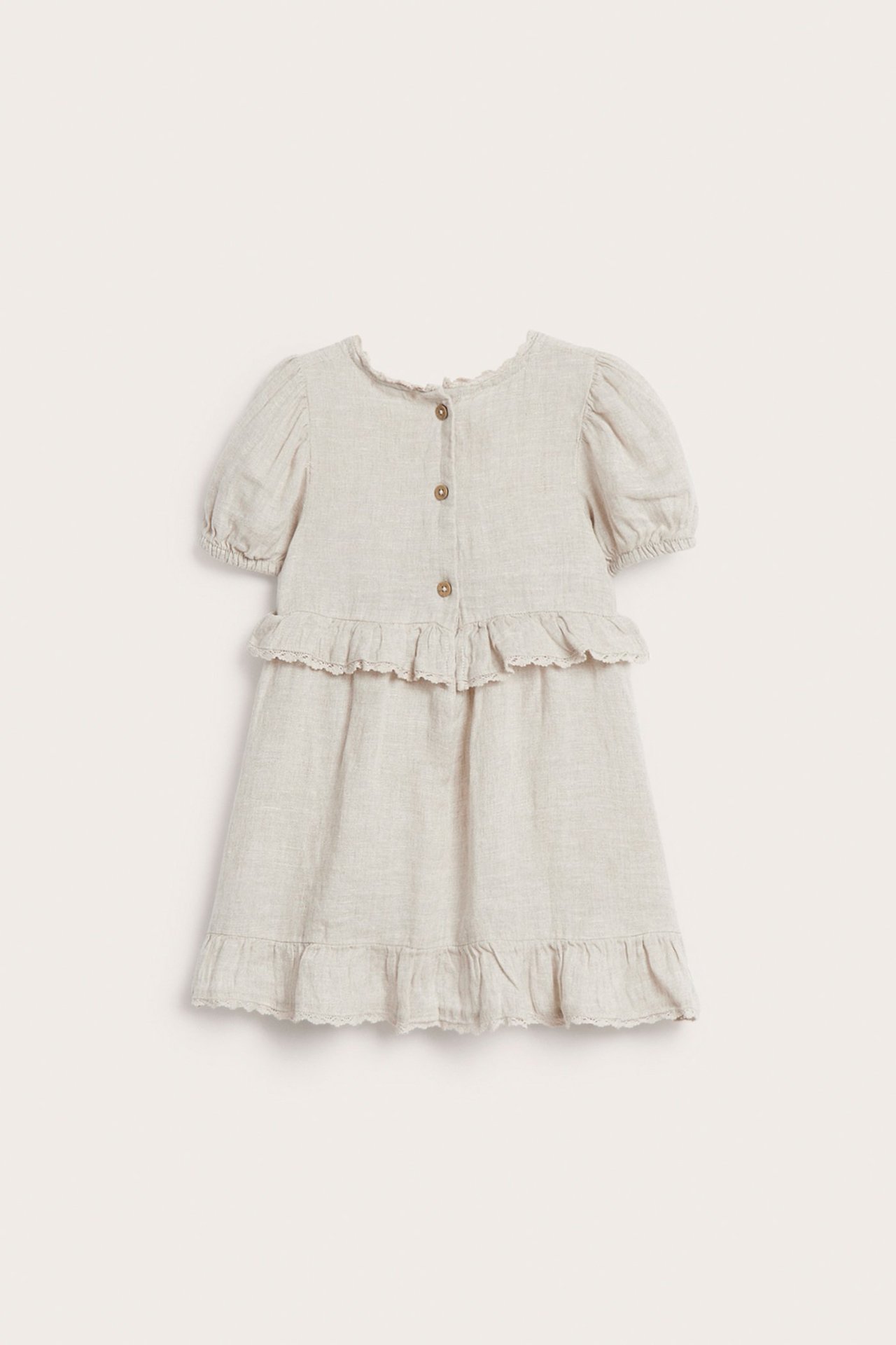 Front view: Kid's light beige linen dress with puff sleeves, ruffles, lace trim, and front buttons.