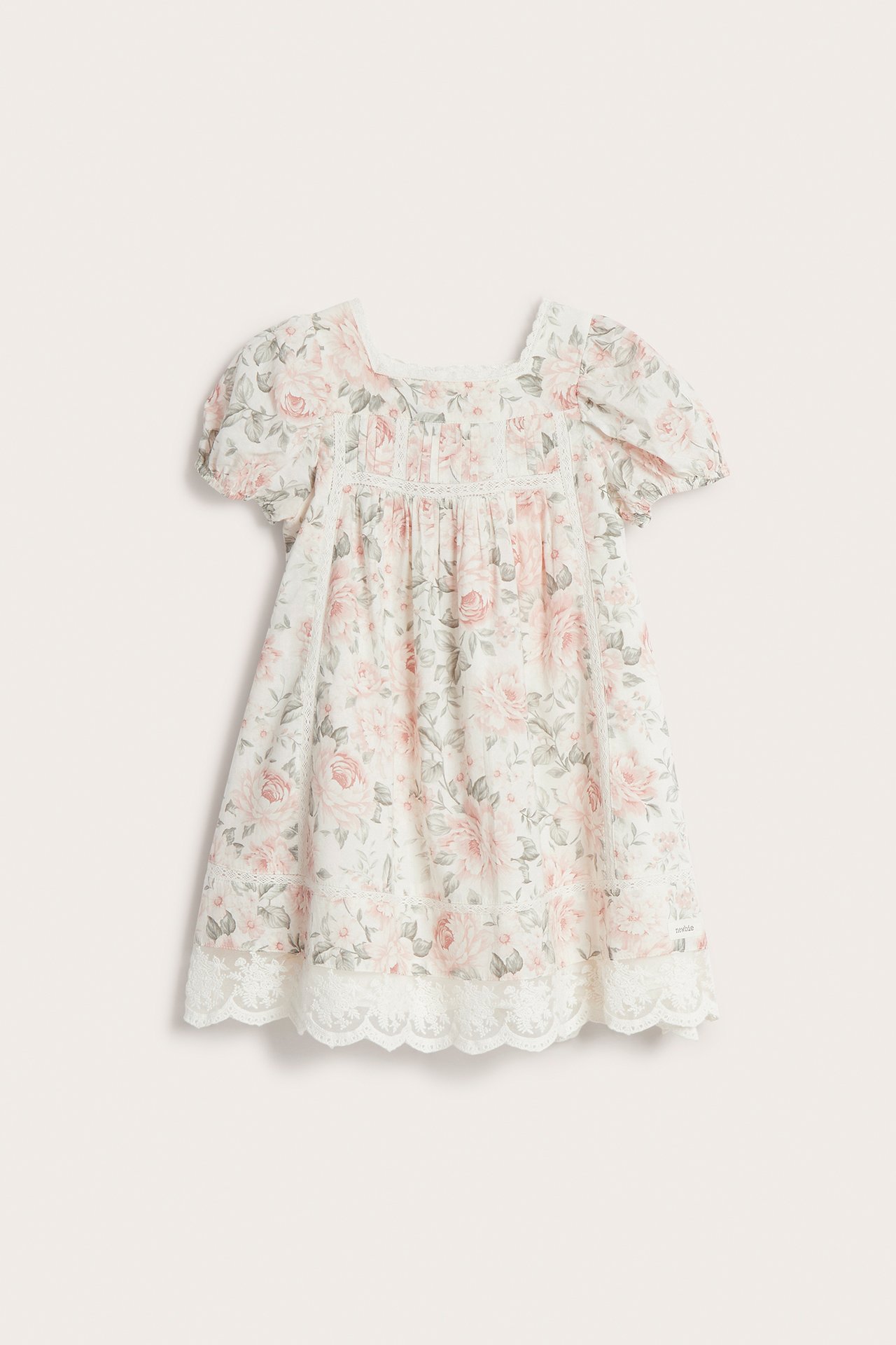 Front view: Off-white cotton floral dress with short puff sleeves, square neckline, and white lace trim.
