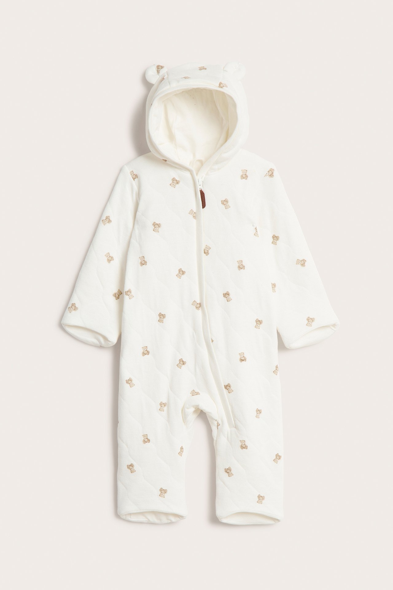 Front view: Offwhite quilted baby overall with teddy bear pattern, hood with ears, and zipper.