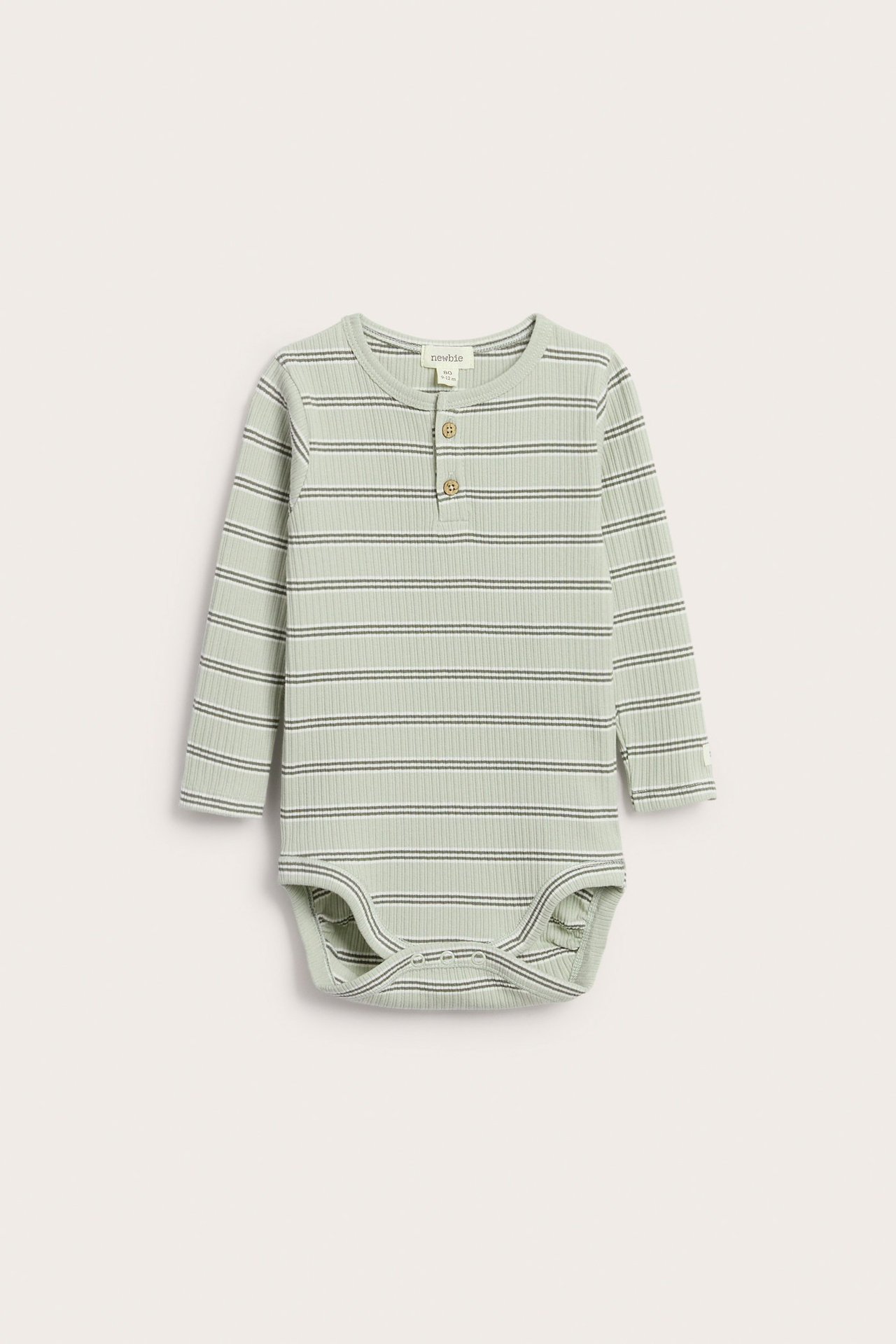Front view: green ribbed long-sleeved baby bodysuit with dark stripes and front buttons.