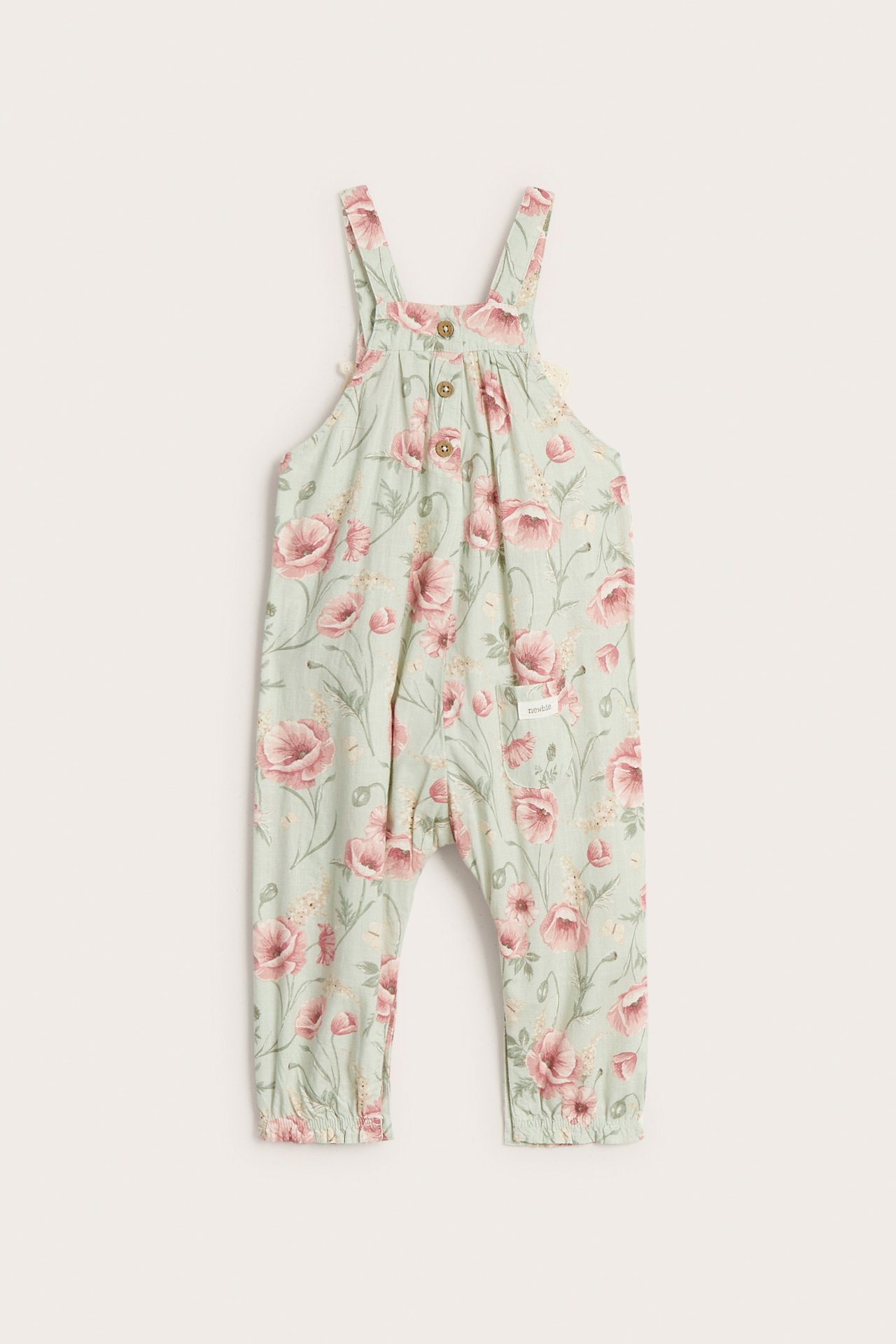 Front view, kid's light green floral overall with buttons on straps and elastic leg cuffs.