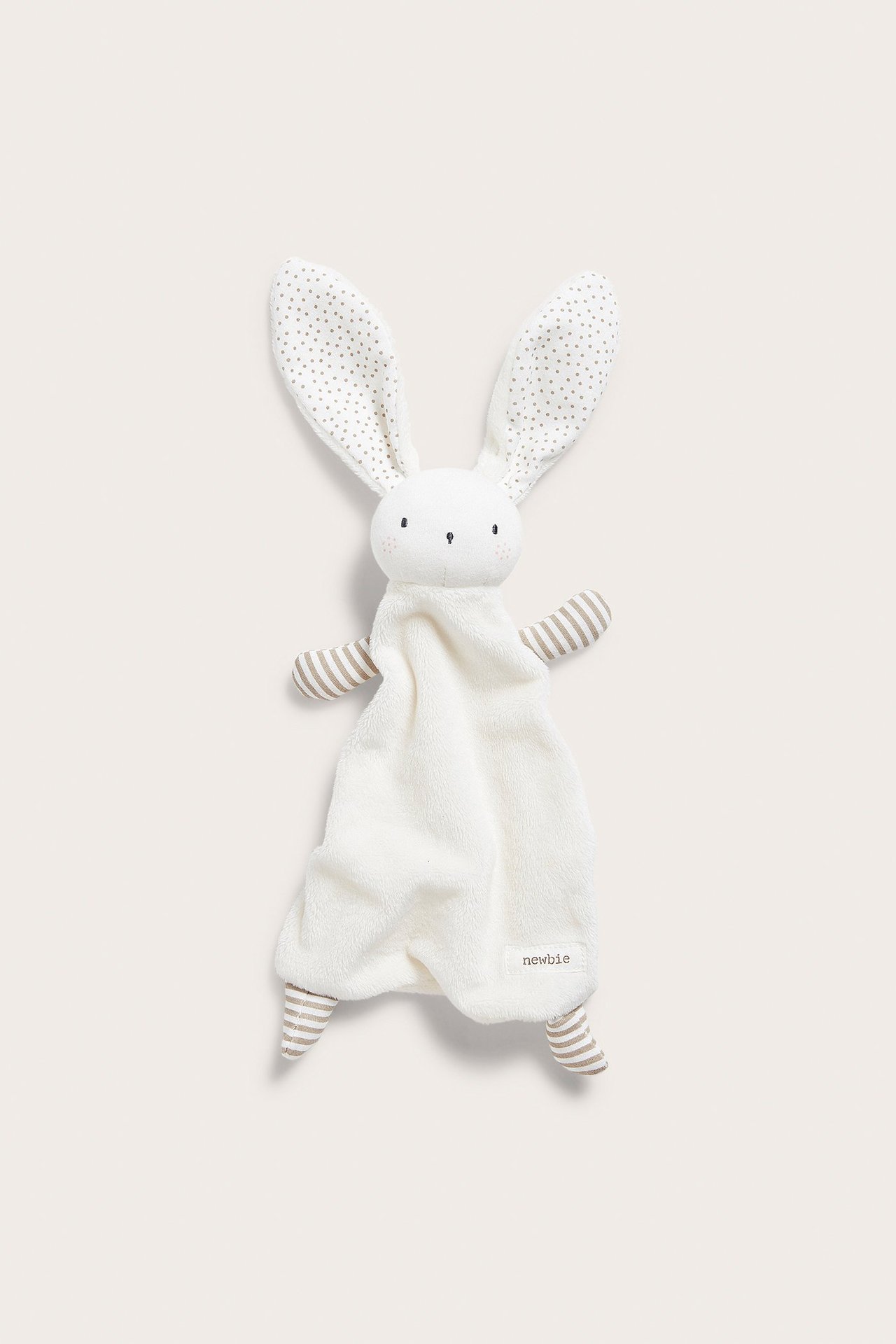 Front view of a soft beige bunny comfort blanket with dotted ears and striped arms/legs for baby.