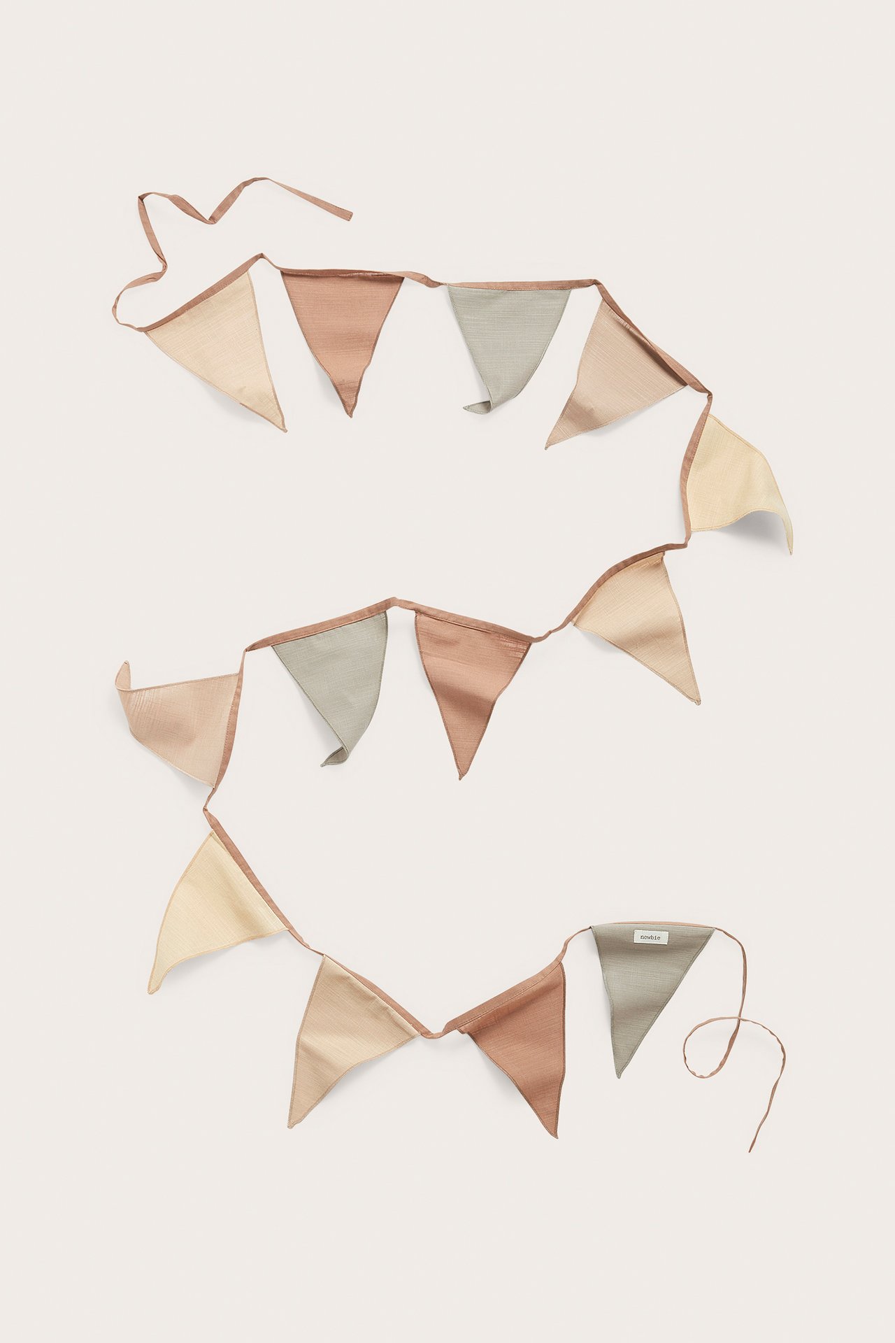 Top-down view: Multicolored cotton pennant string with beige, green, and terracotta triangular flags.
