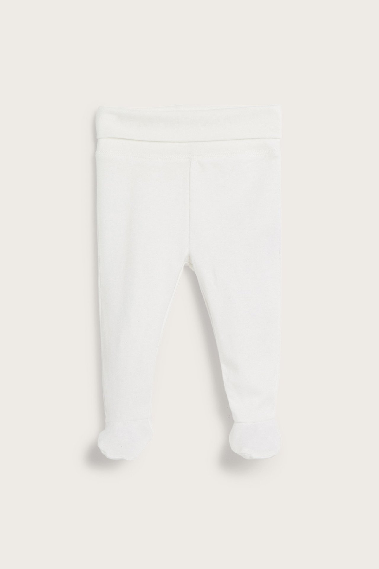 Front view of offwhite solid cotton baby leggings with feet and a wide foldable waistband.