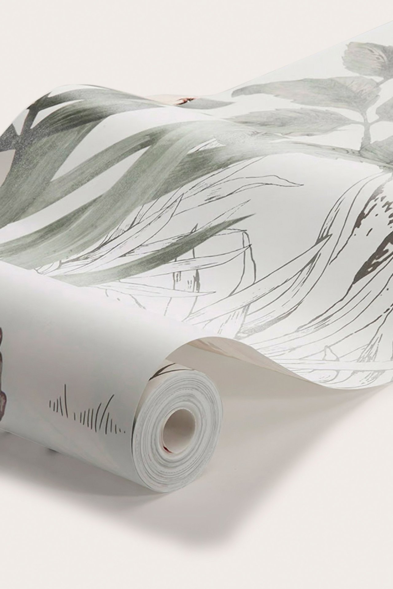 Close-up of a partially unrolled non-woven wallpaper in light grey with a grey-green forest and subtle coral animal pattern.