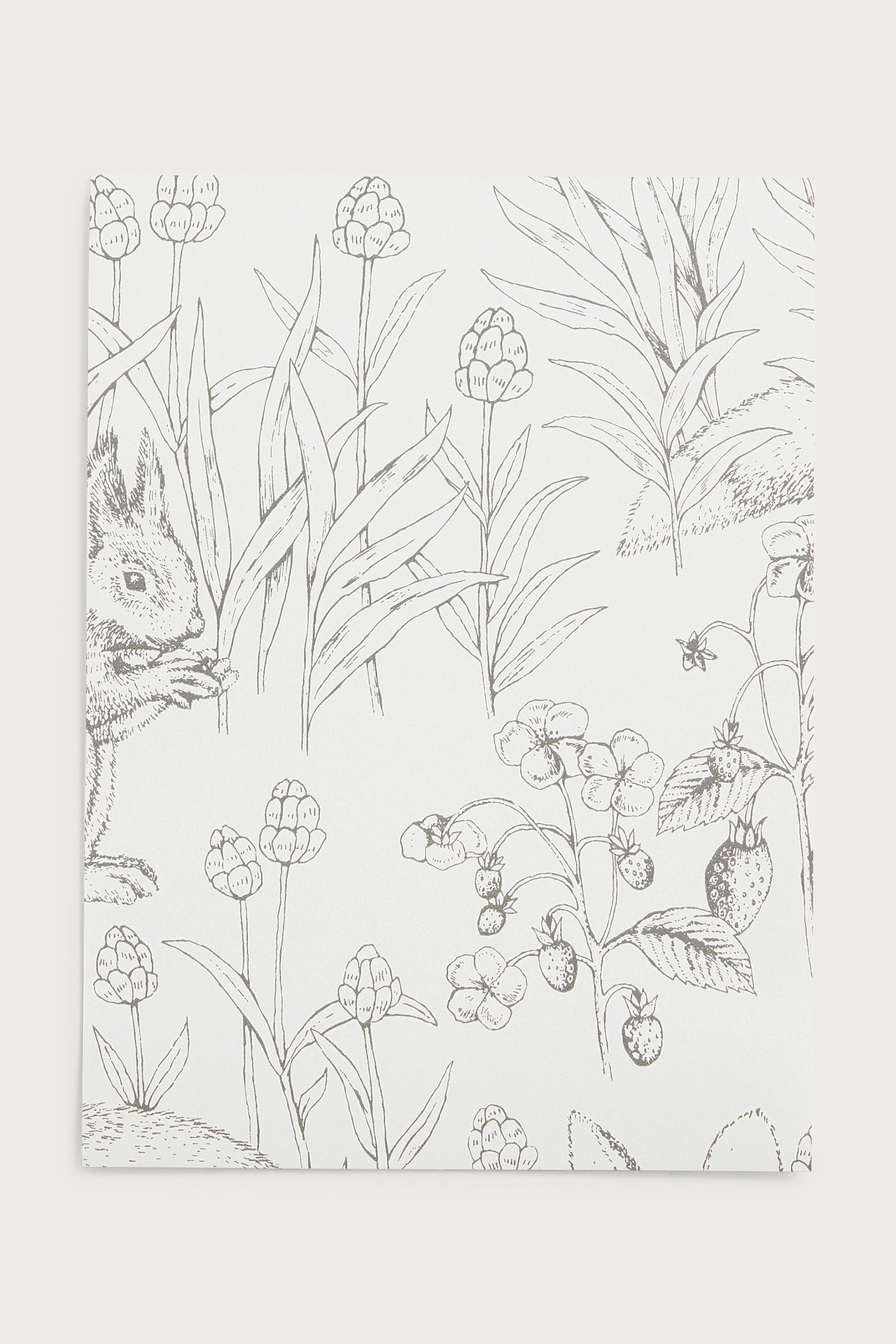 Close-up of a white wallpaper sample with a gray forest pattern: squirrel, plants, strawberries.