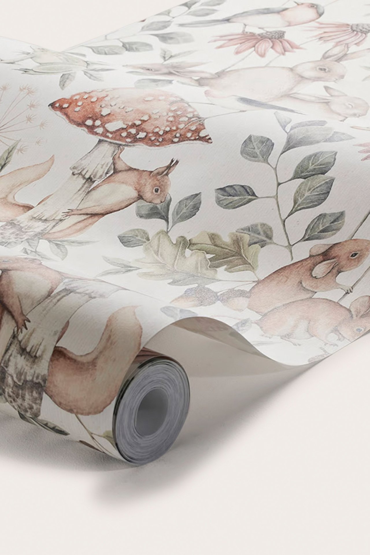 Close-up of an offwhite non-woven wallpaper roll featuring a pattern of forest animals and plants.