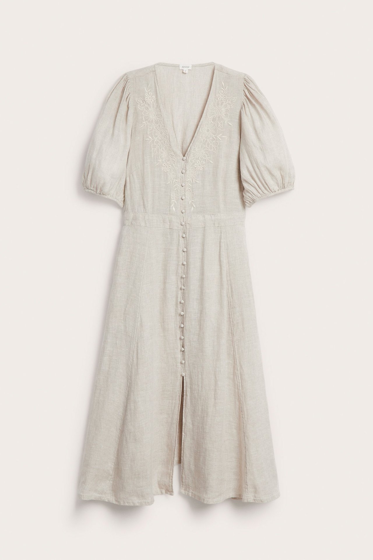 Front view: light beige linen dress with front buttons, puff sleeves, and white embroidery on the bodice.