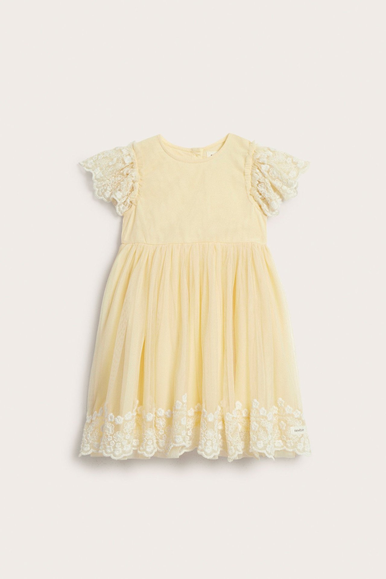Front view of a yellow kid's mesh dress with embroidered short sleeves and a delicate embroidered hem.