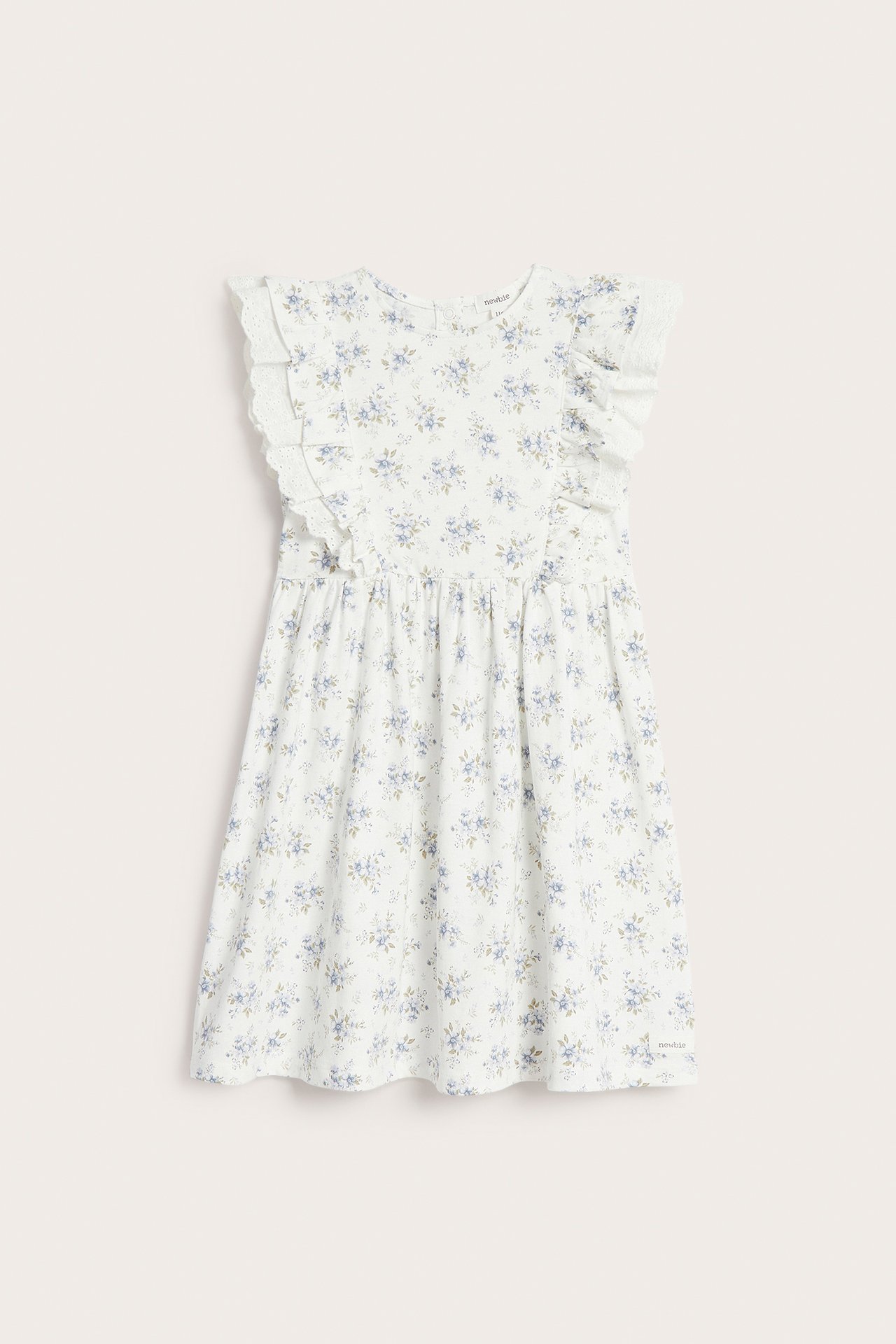 Front view: Off-white cotton jersey dress with blue floral print, shoulder ruffles, and lace.