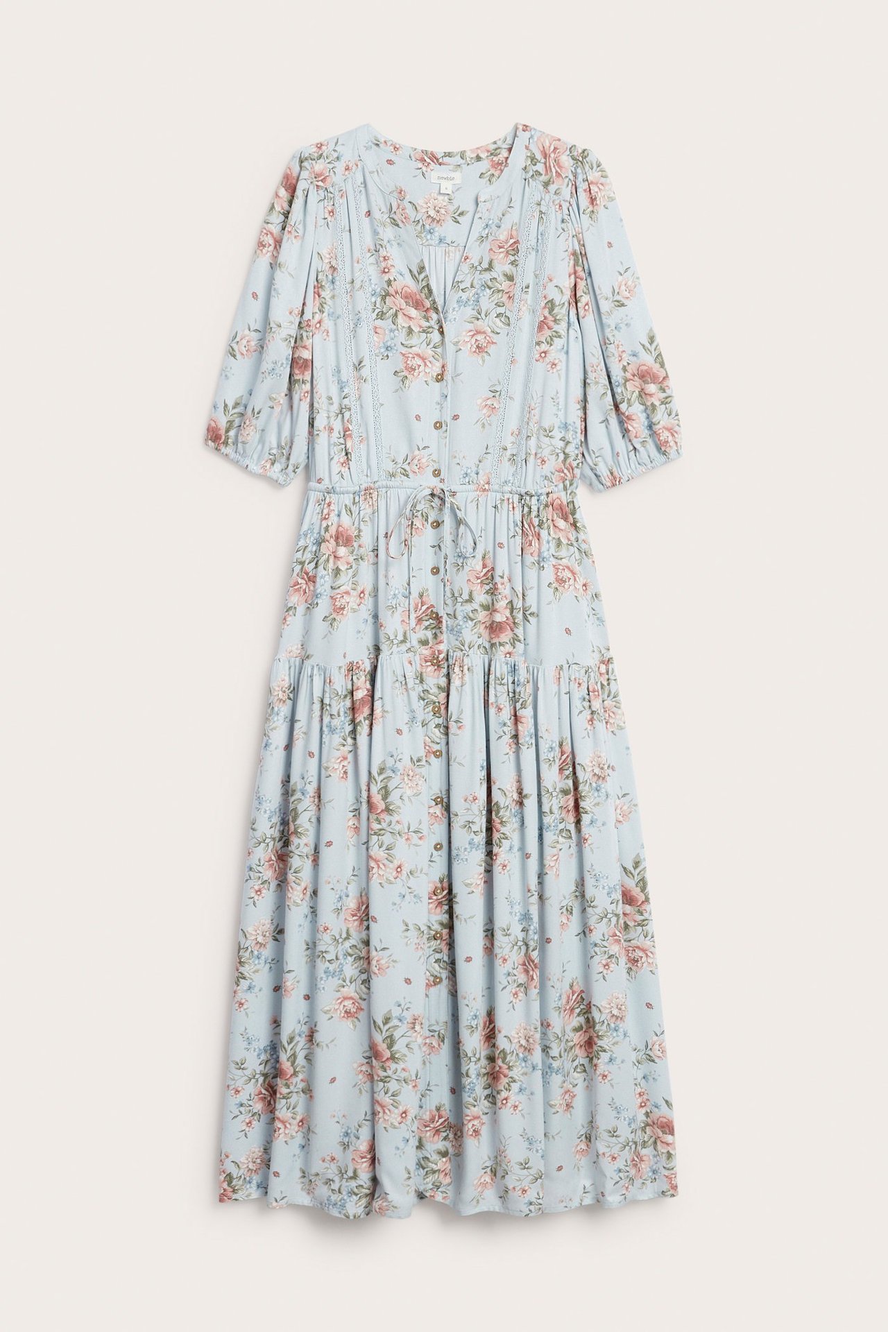Vorderansicht eines hellblauen geblümten Viskosekleides mit Knöpfen, Spitze, Kordelzug und Puffärmeln.