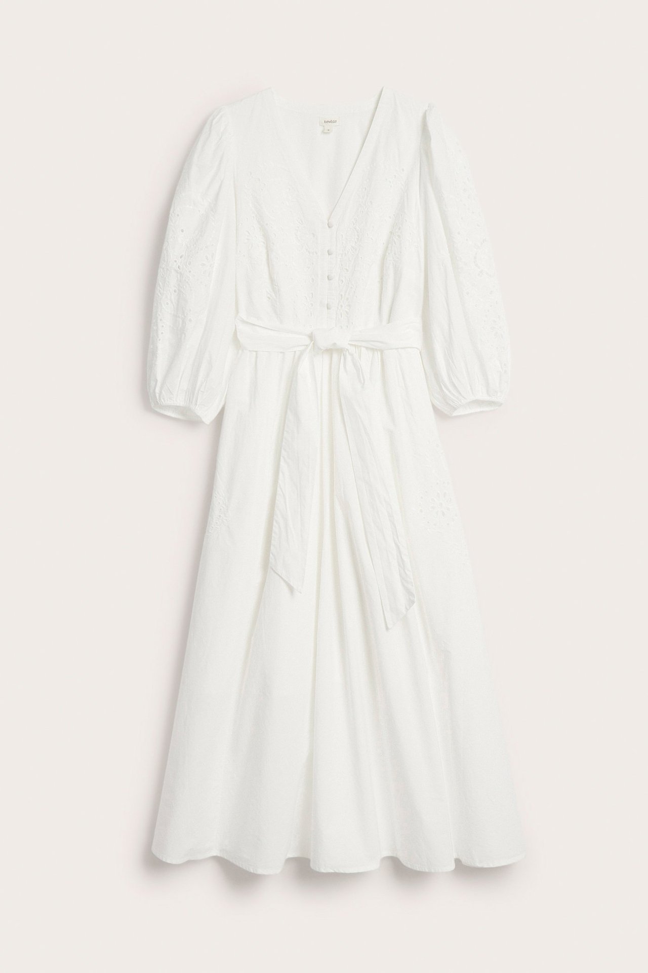 Front view: Off-white cotton dress with embroidery, front buttons, waist tie belt, and 3/4 puff sleeves.