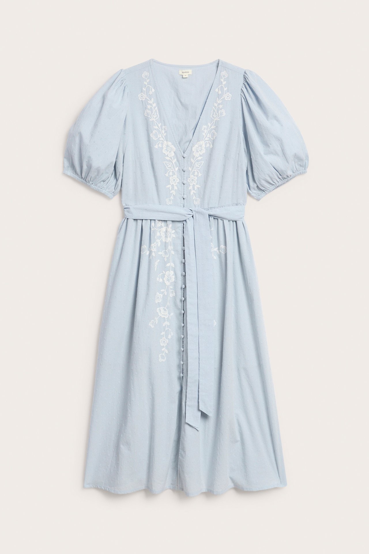 Front view: Light blue cotton dress with white floral embroidery, puff sleeves, and a self-tie belt.