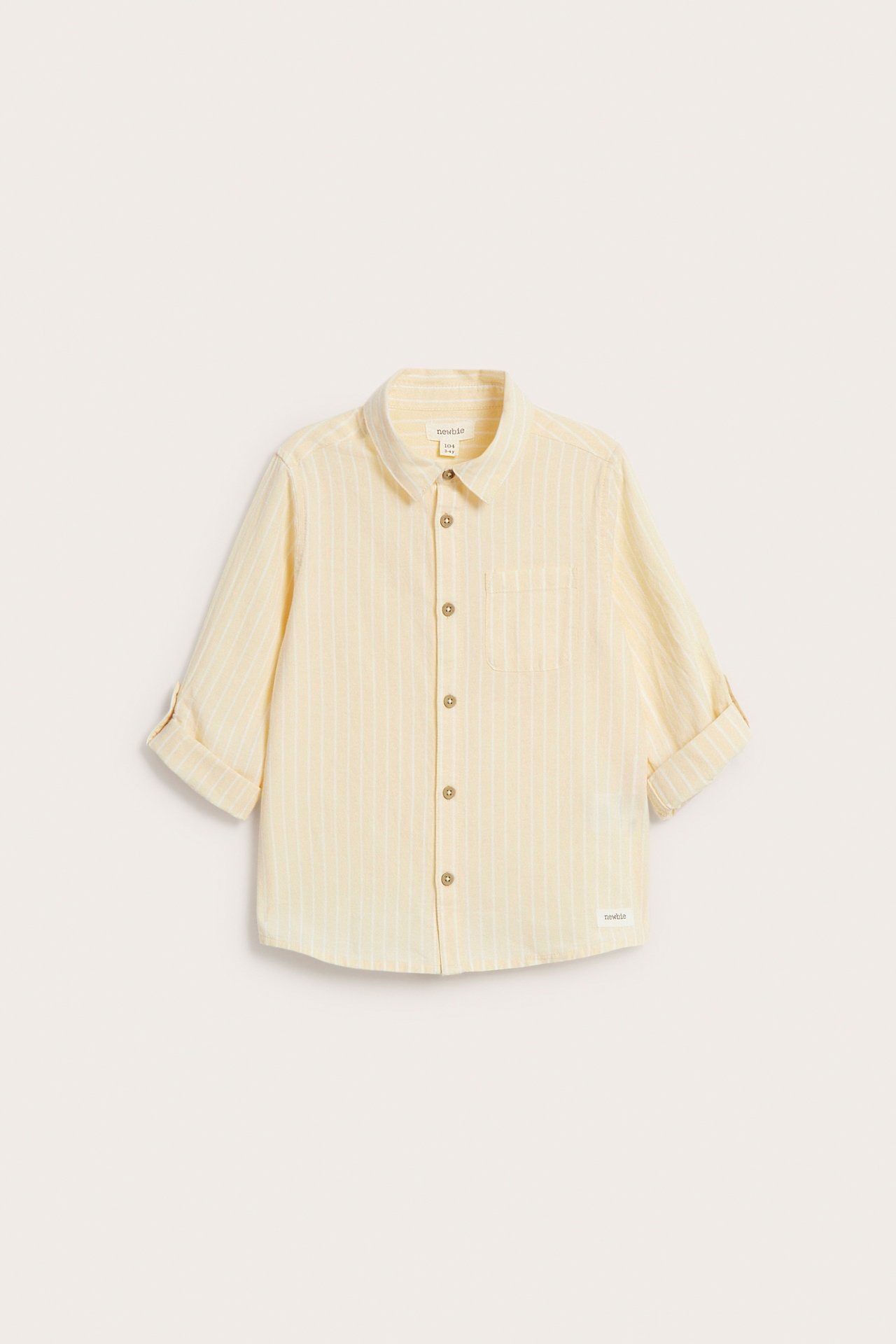 Front view of a kid's yellow and white striped woven cotton shirt with collar, buttons, and rolled-up sleeves.
