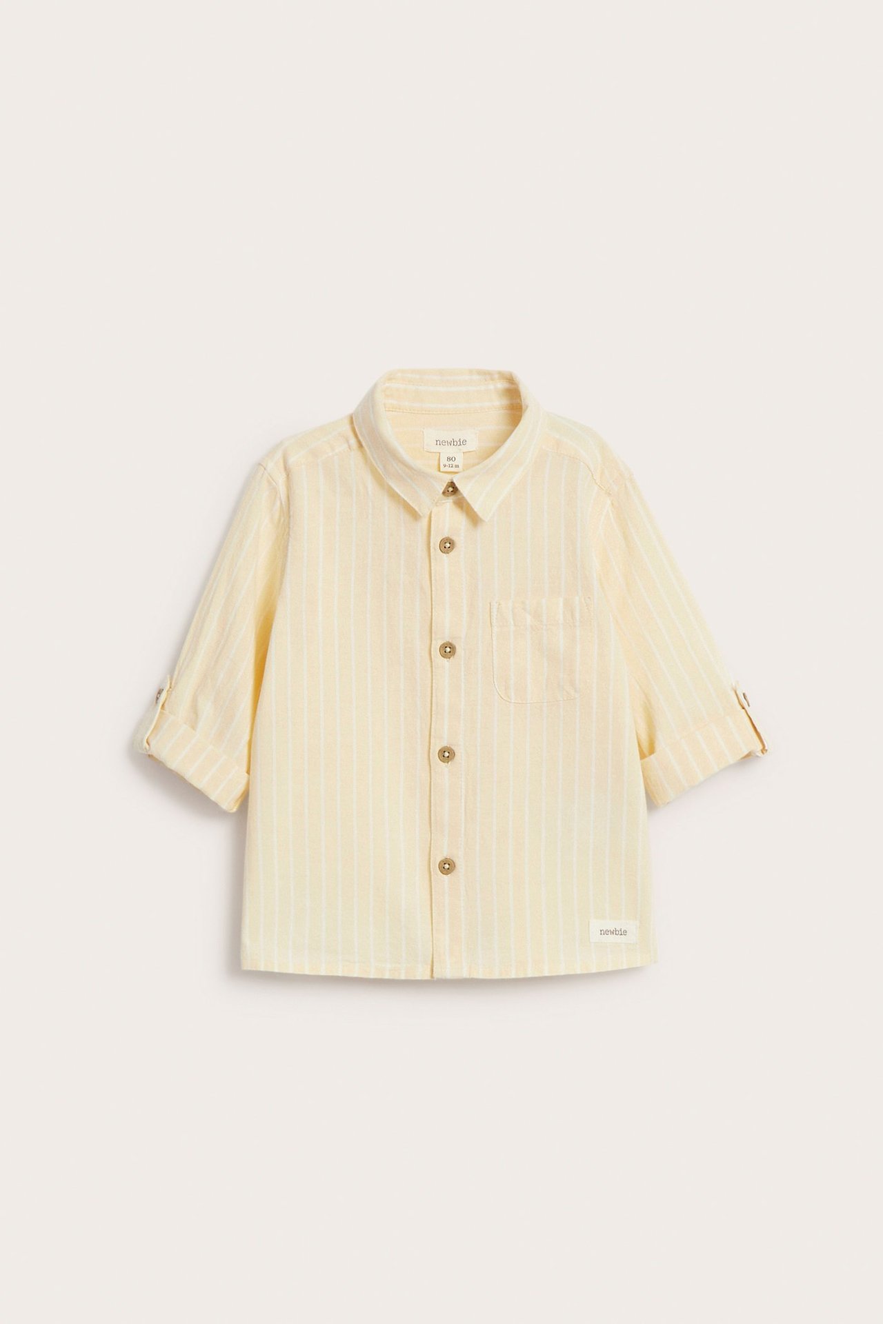 Front view of a kid's yellow striped cotton shirt with collar, front buttons, chest pocket, rolled sleeves.