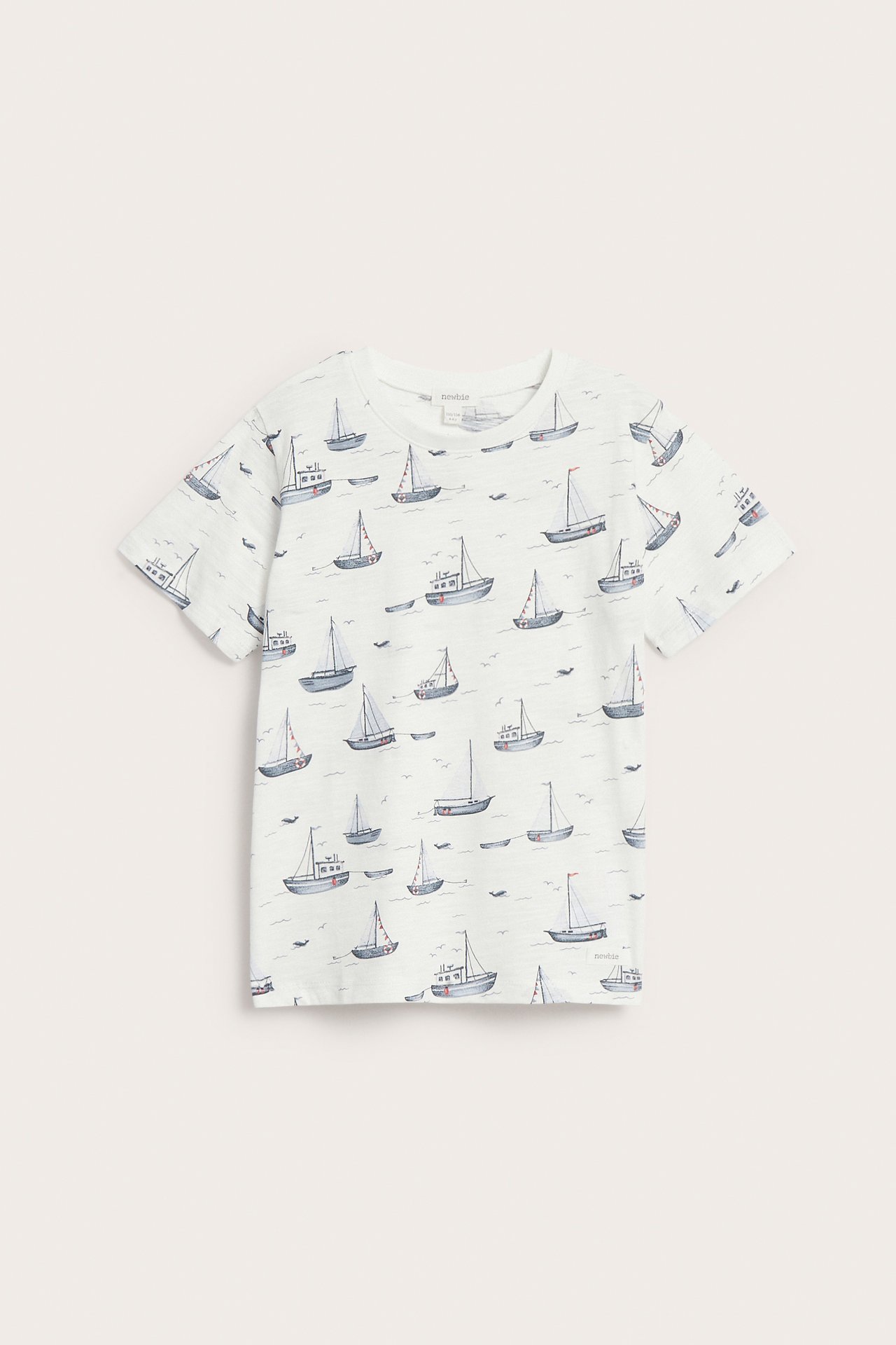 Front view of an off-white short-sleeved slub jersey t-shirt with an all-over sailboat pattern.