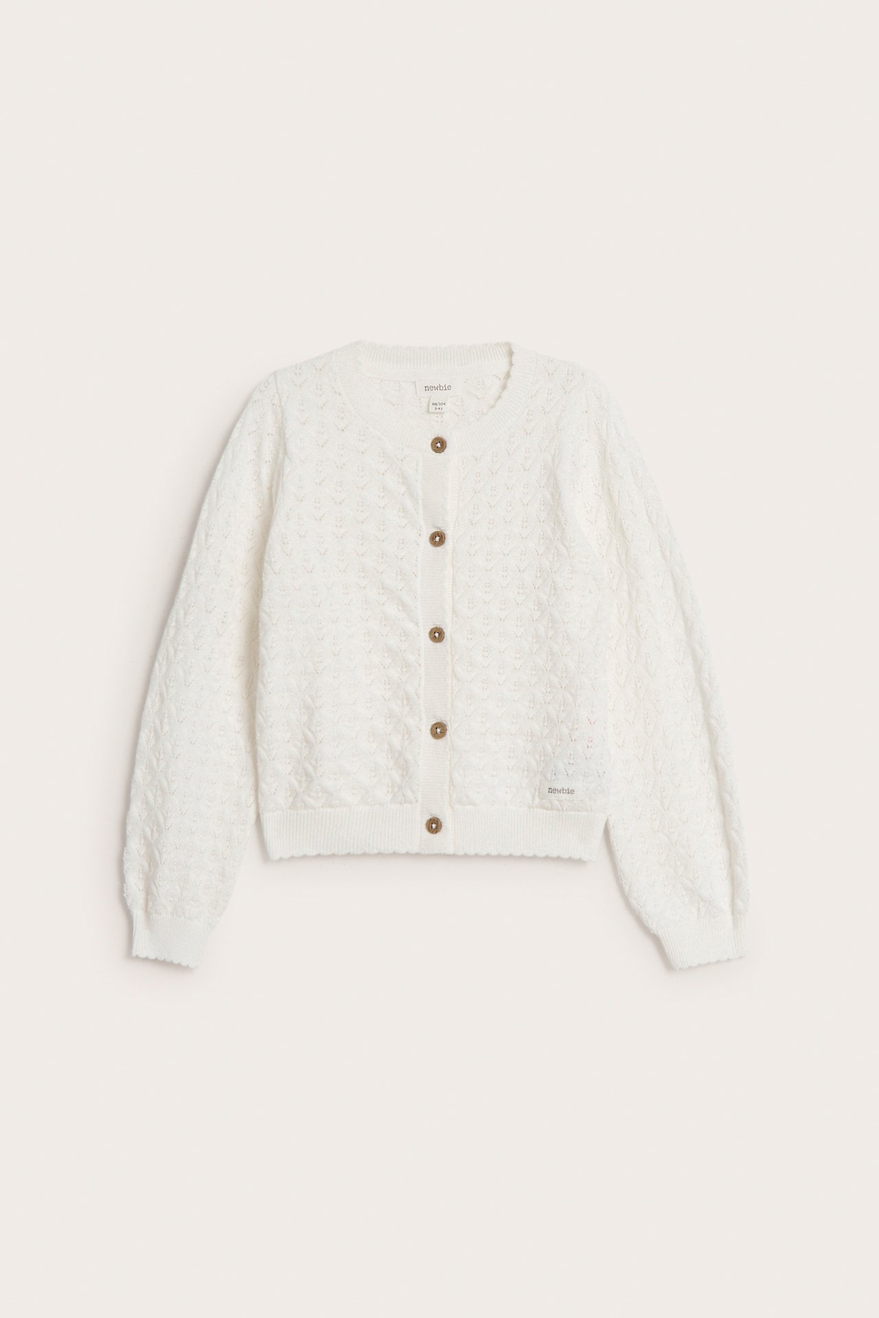 Front view of an off-white patterned knitted cotton cardigan with brown buttons and scalloped edges.