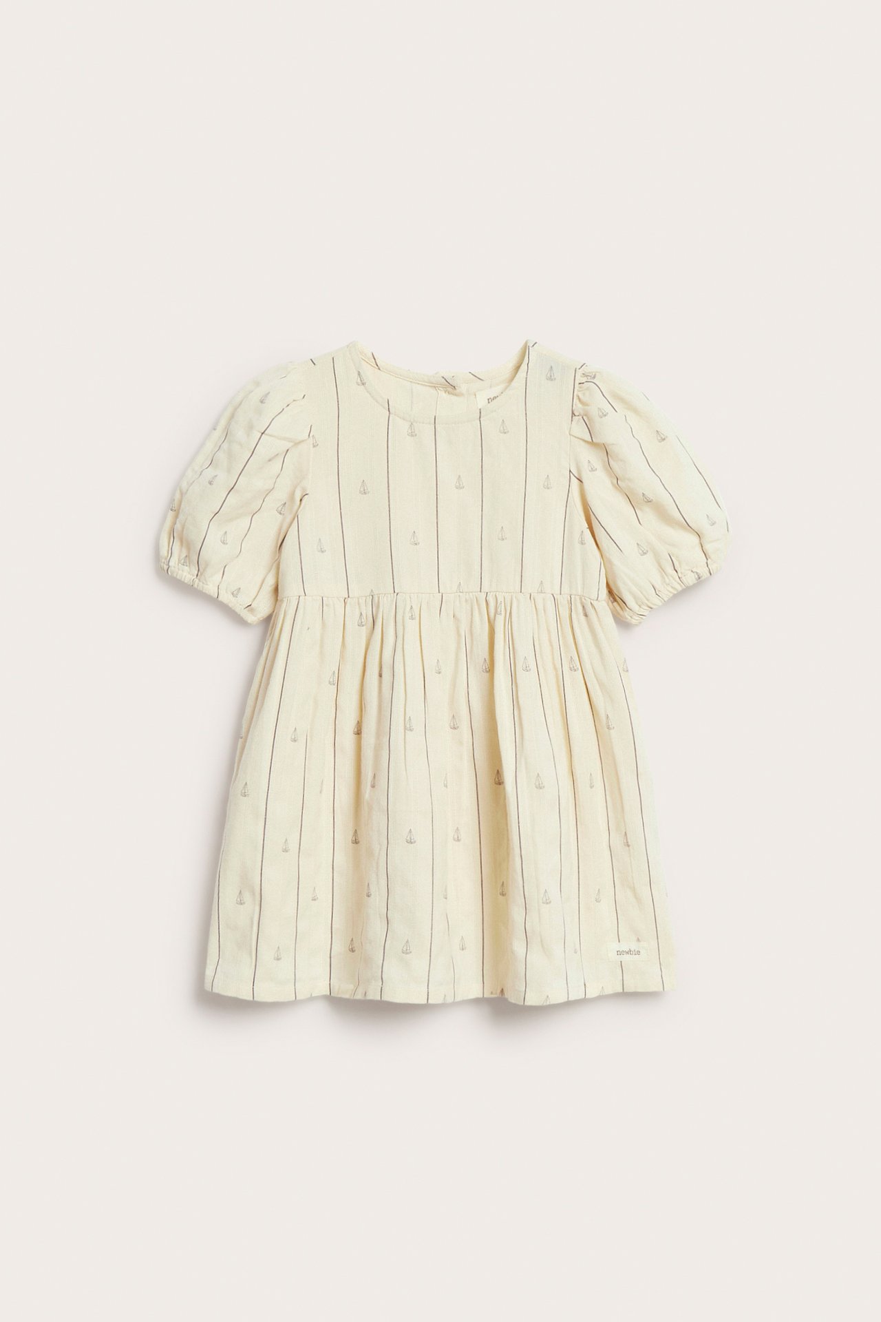Front view of an off-white cotton kid's dress with grey stripes, sailboat prints, and puff sleeves.