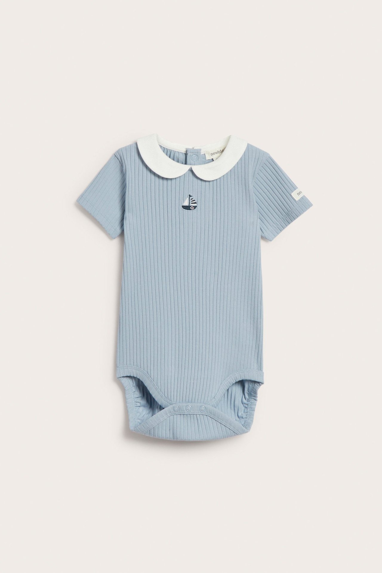 Front view: Light blue ribbed baby bodysuit with white collar, boat embroidery, and snap buttons.