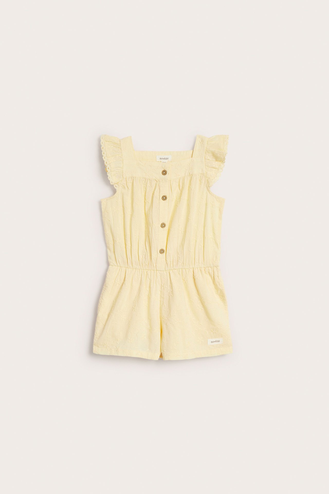 Front view: Yellow embroidered woven short-legged jumpsuit with ruffled sleeves, front buttons, and elastic waist.