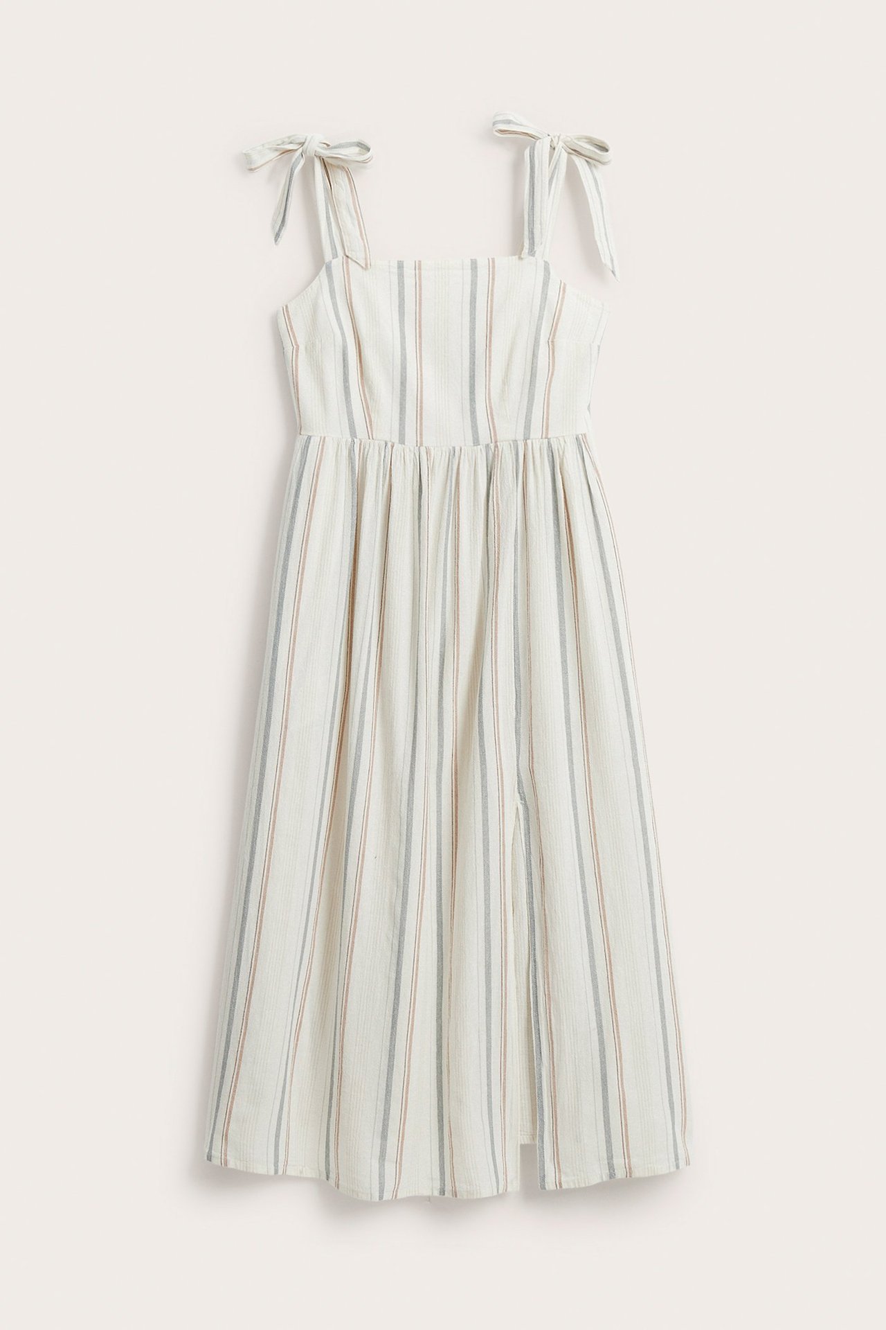 Front view: Off-white striped cotton dress with tie-shoulder straps, gathered waist, and side slit.