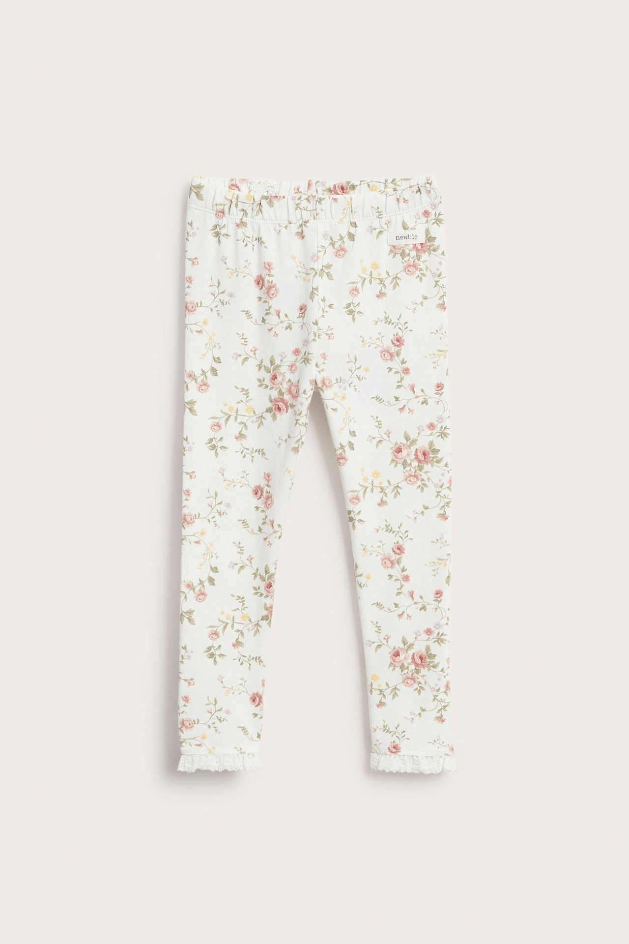 Vorderansicht: Off-white Kinder-Leggings mit Blumenmuster, Spitzenrüsche am Beinabschluss und Gummizugbund.